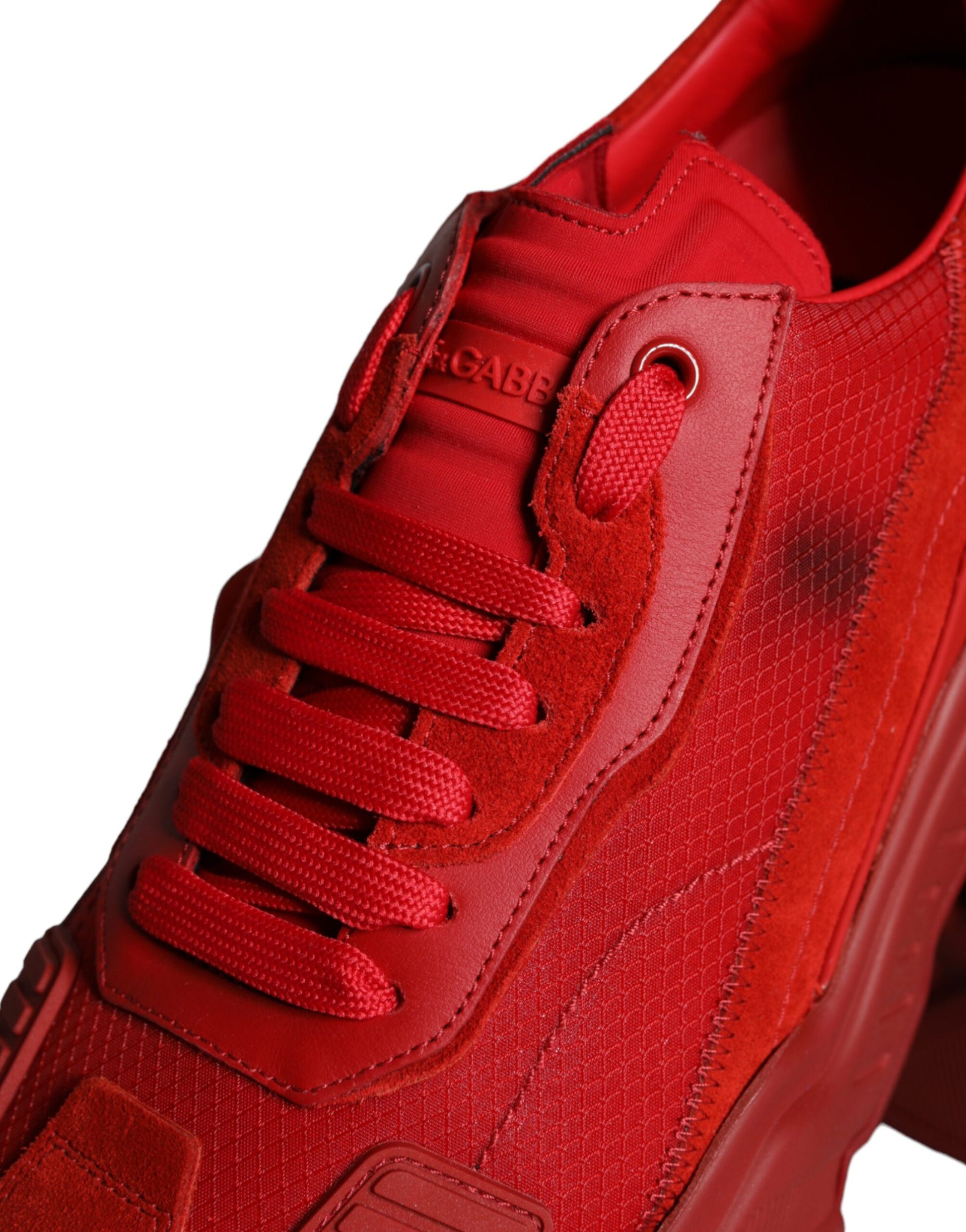 A pair of red leather sneakers with a low top, featuring the brand name on the side