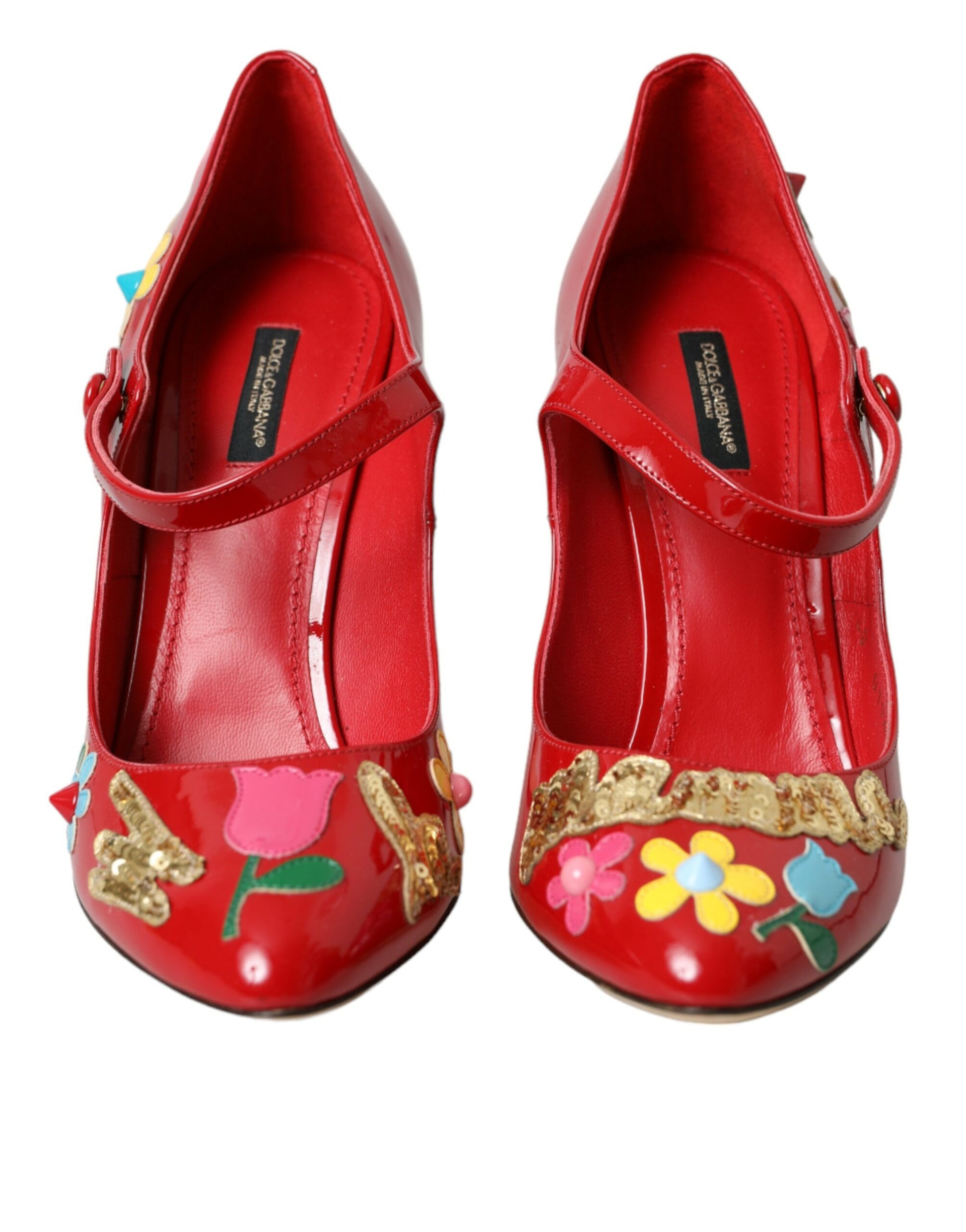 Red shoes with floral designs and gold accents