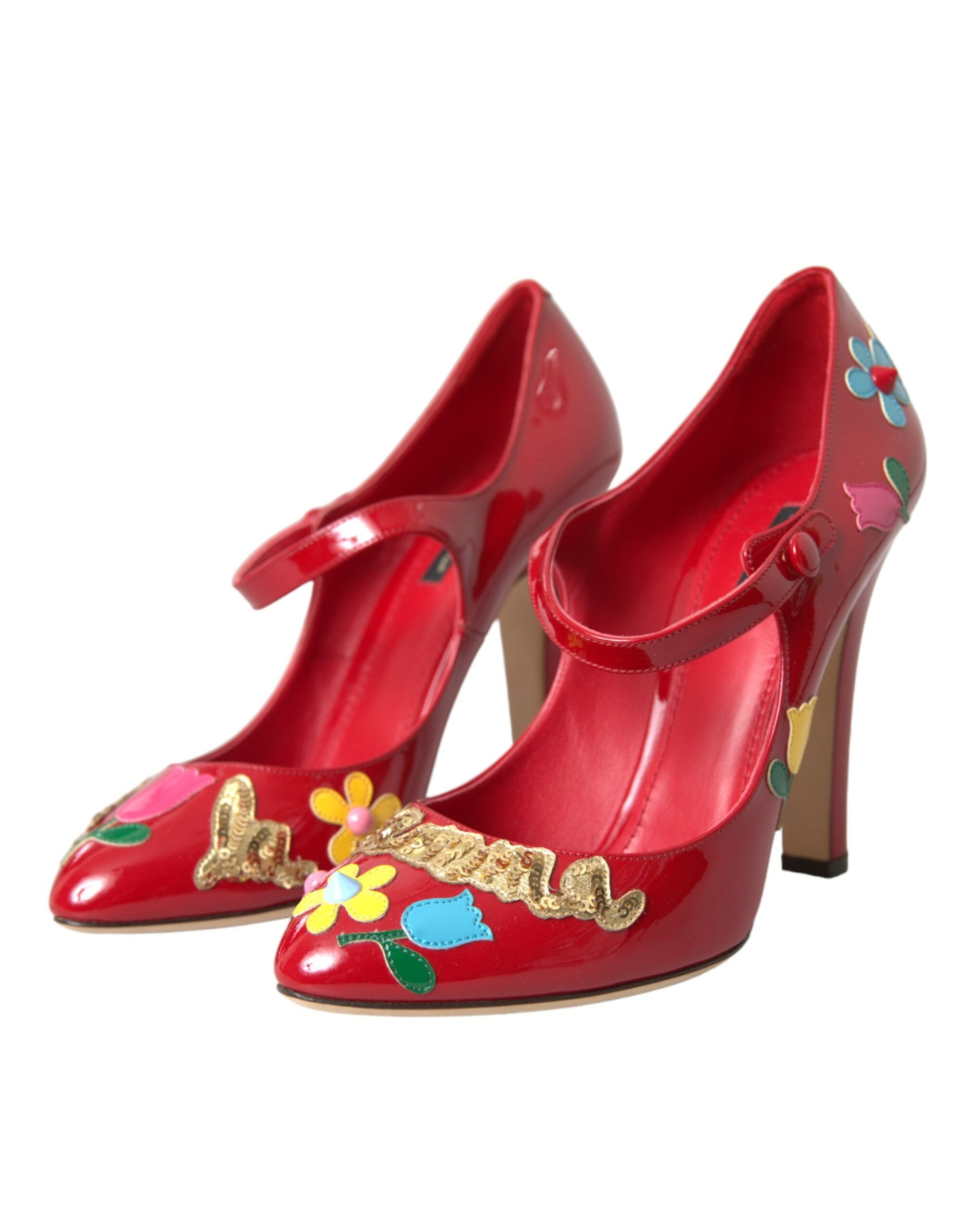 Red high heel shoes with floral embellishments and gold accents