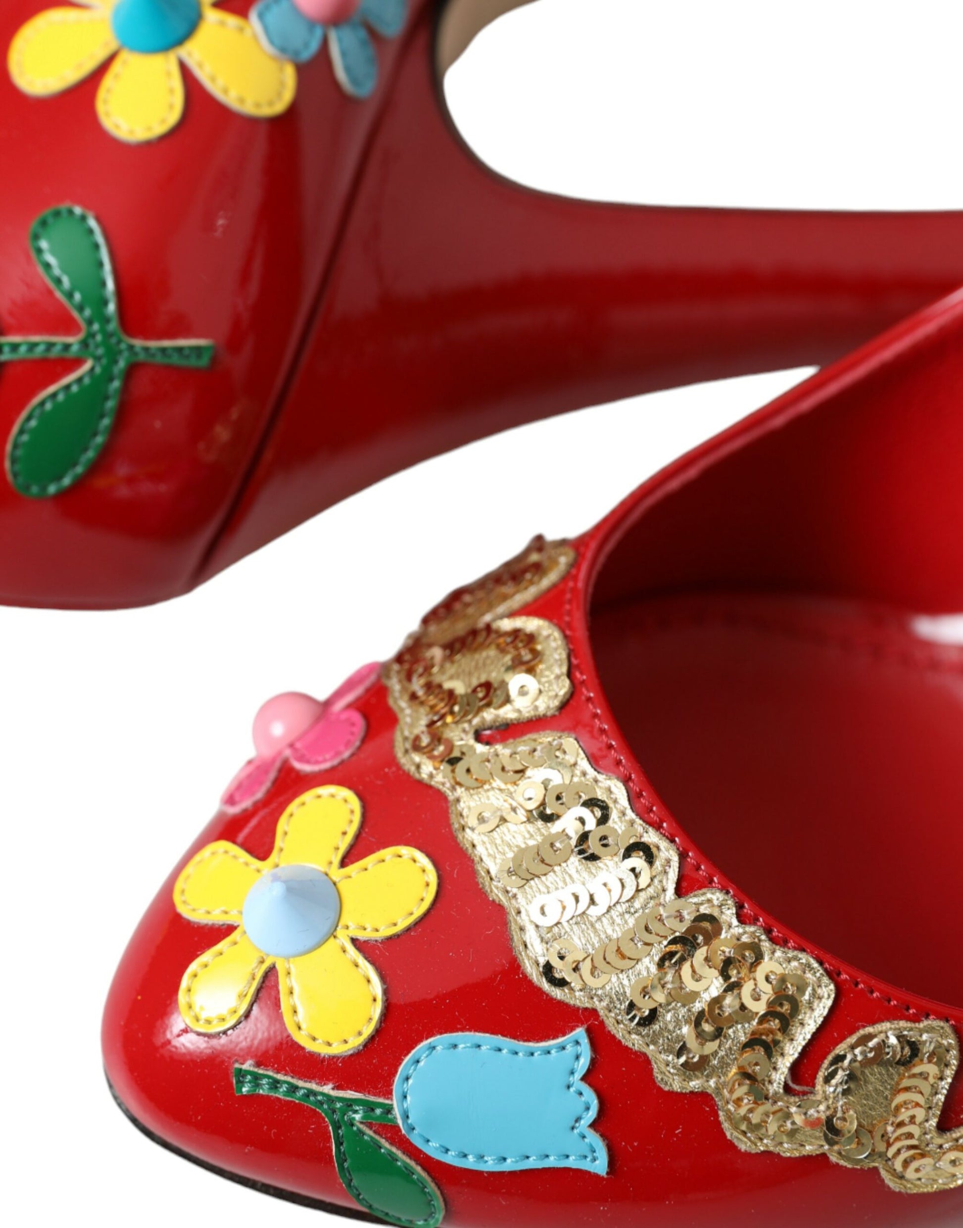 Red high heel shoe with floral embroidery and gold accents