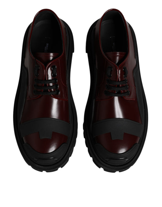 Pair of red leather lace-up shoes with black accents and a chunky sole