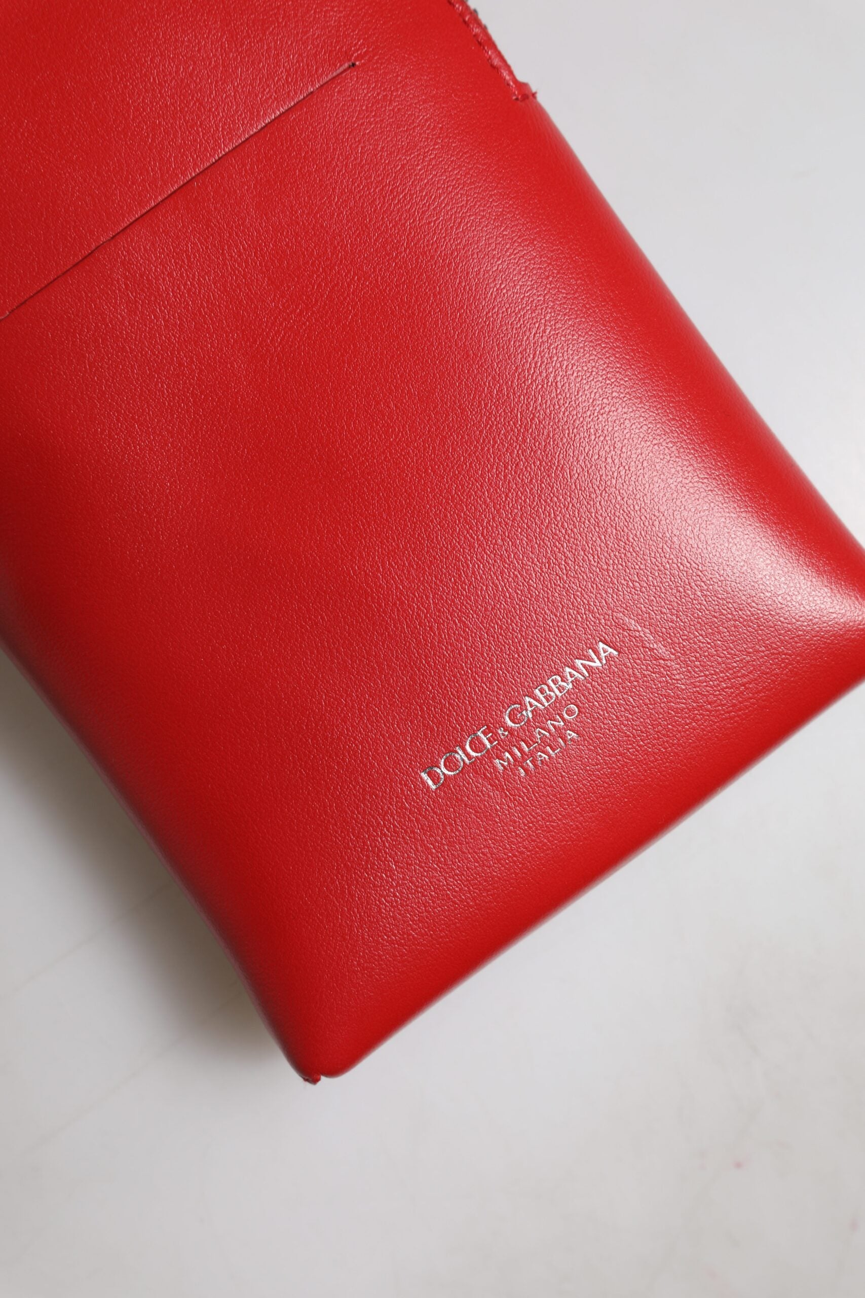 Red wallet on white surface