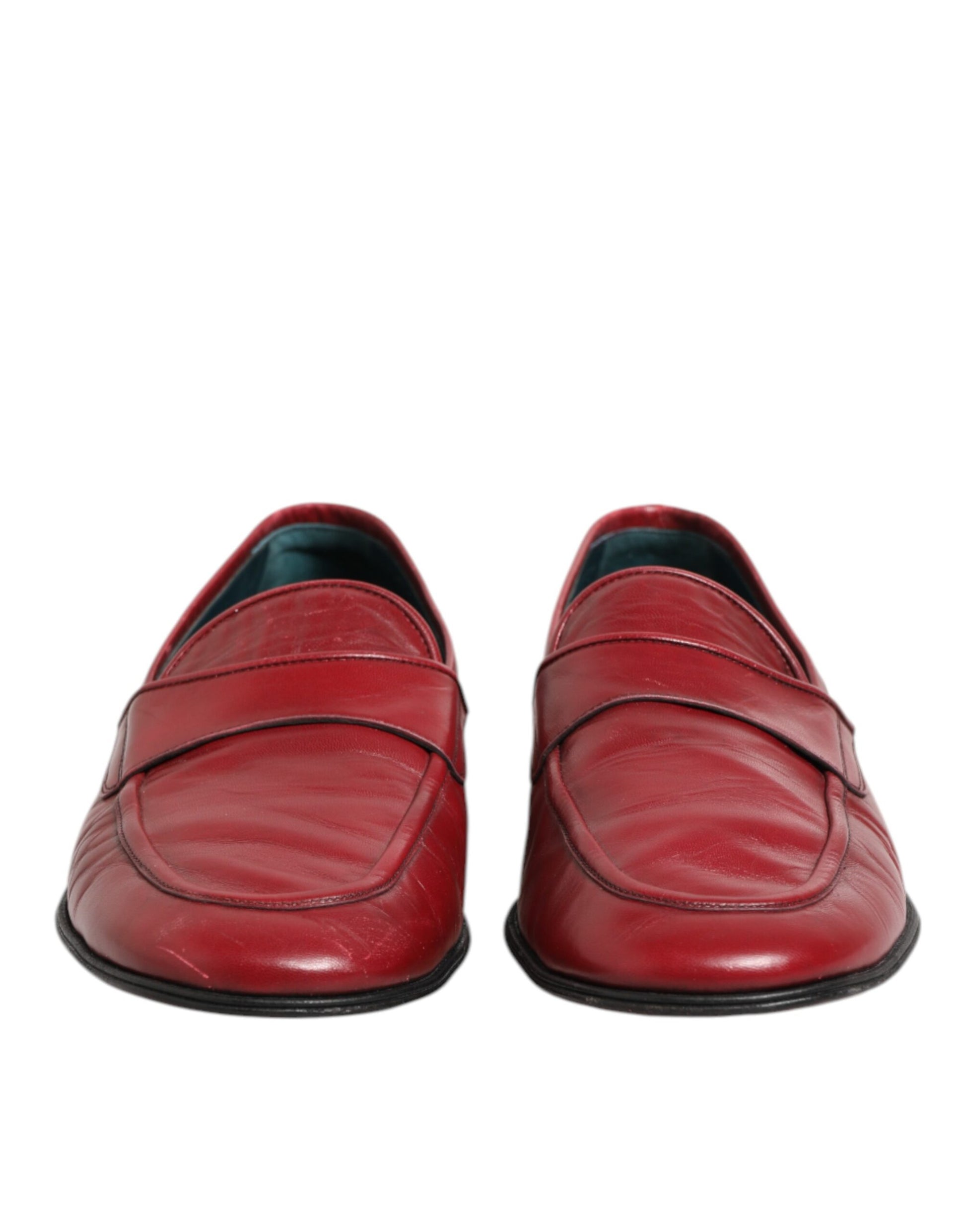 A pair of red leather slip-on loafers with black soles