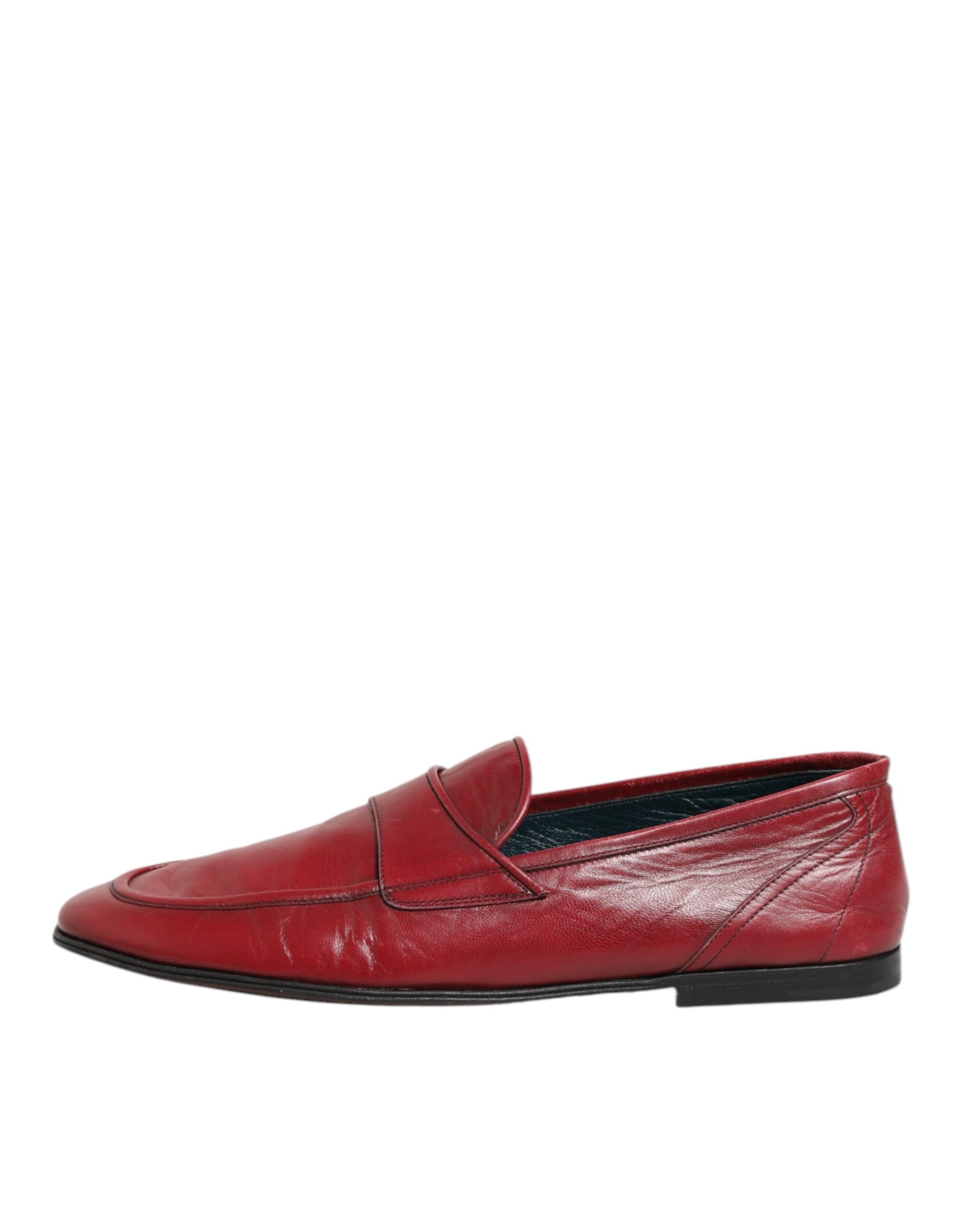 A pair of red leather slip-on loafers with a strap across the top