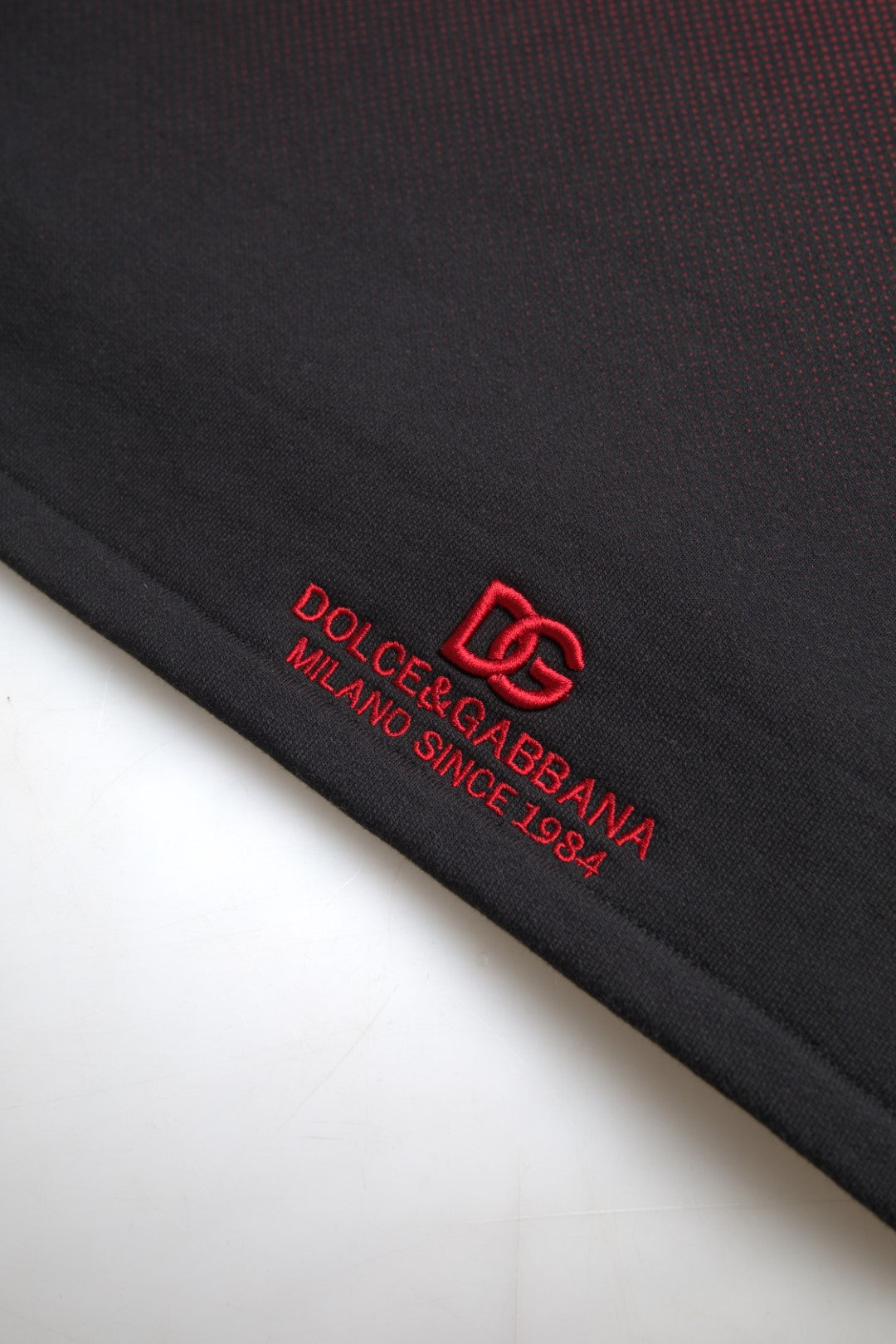 Black fabric with red logo and text