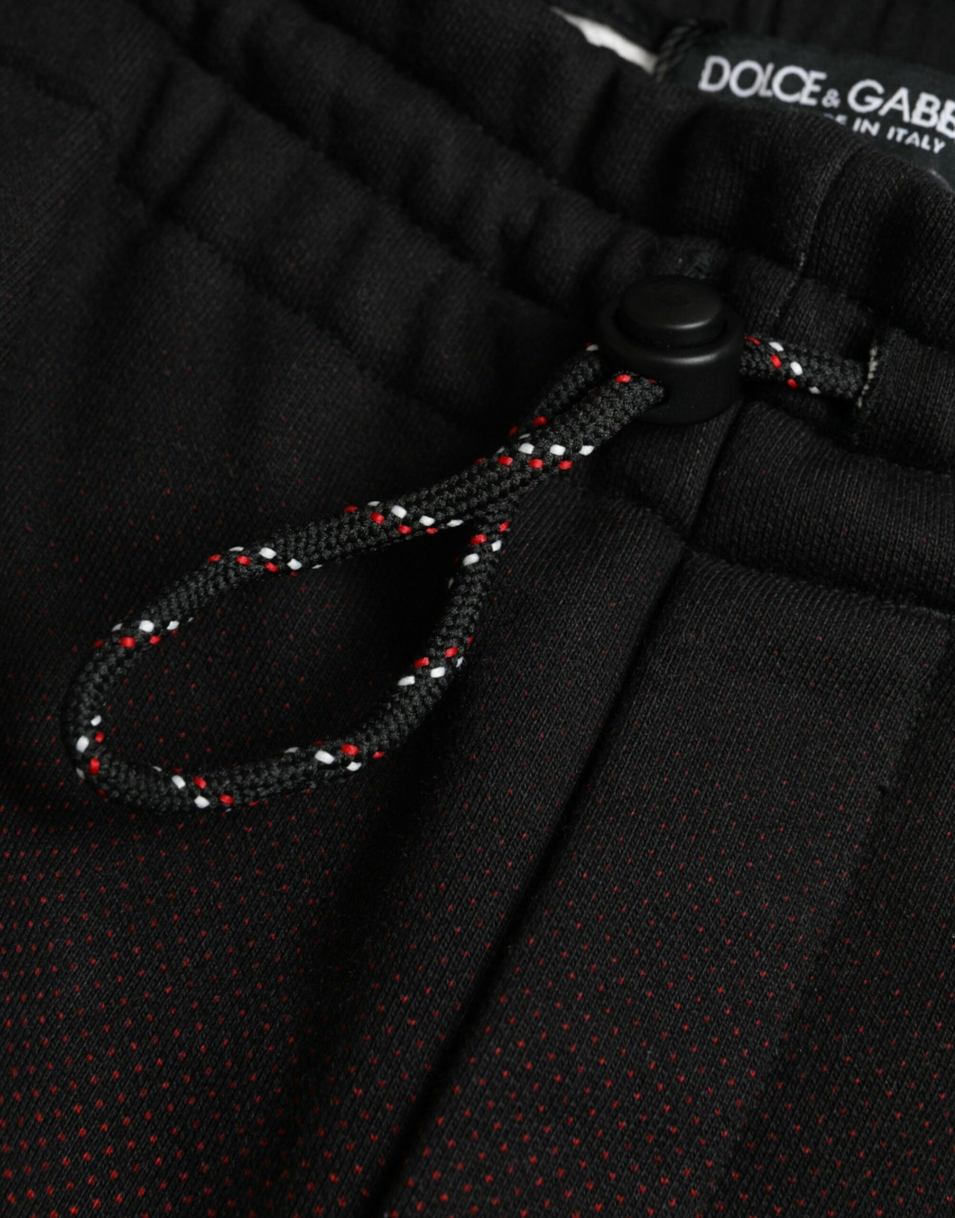 Black pants with red and white patterned drawstring