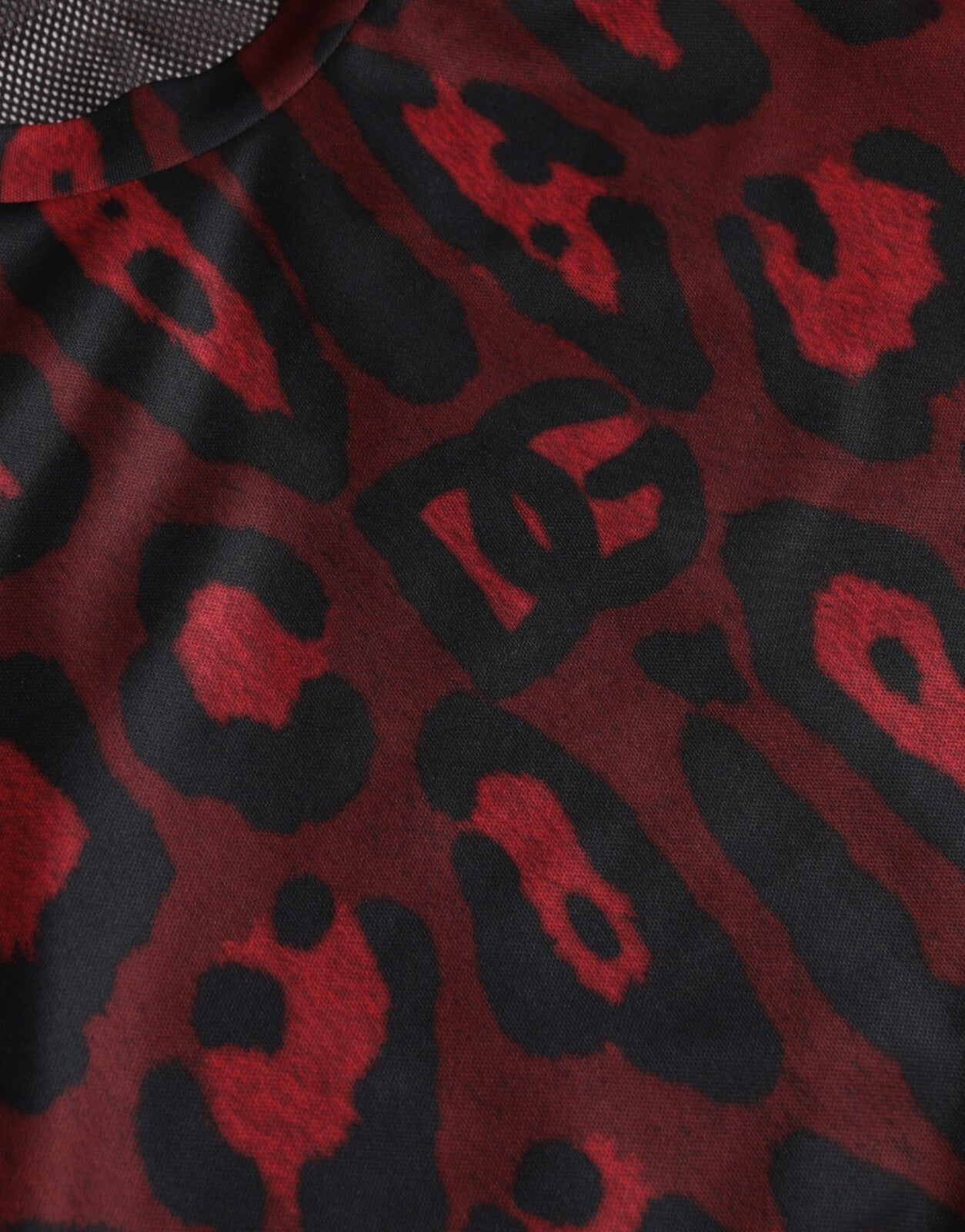 Leopard print fabric with red spots on black background