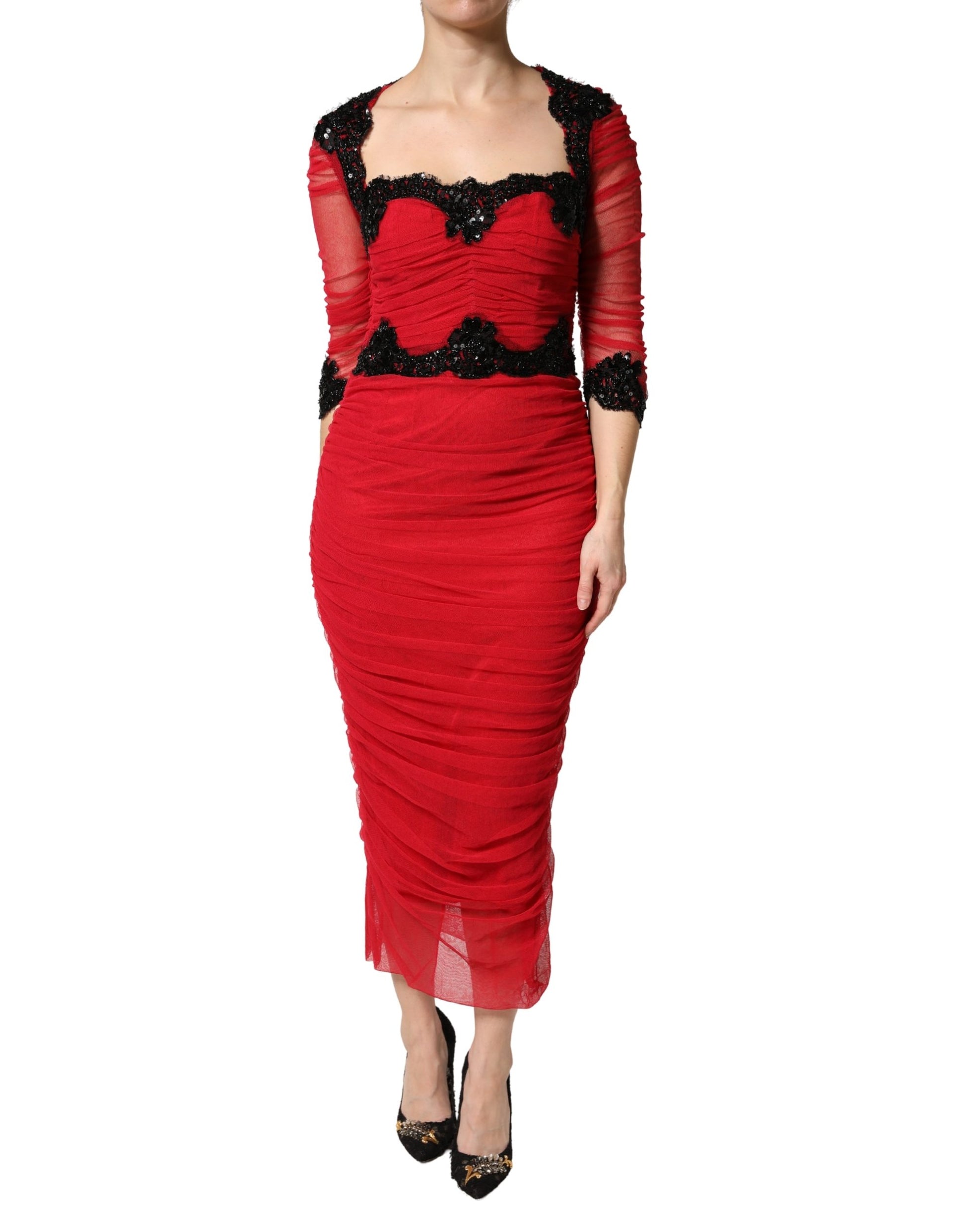 A red bodycon dress with mesh trim from Dolce & Gabbana, featuring a midi length and high neckline