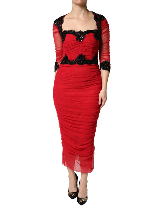 A red bodycon dress with mesh trim from Dolce & Gabbana, featuring a midi length and high neckline