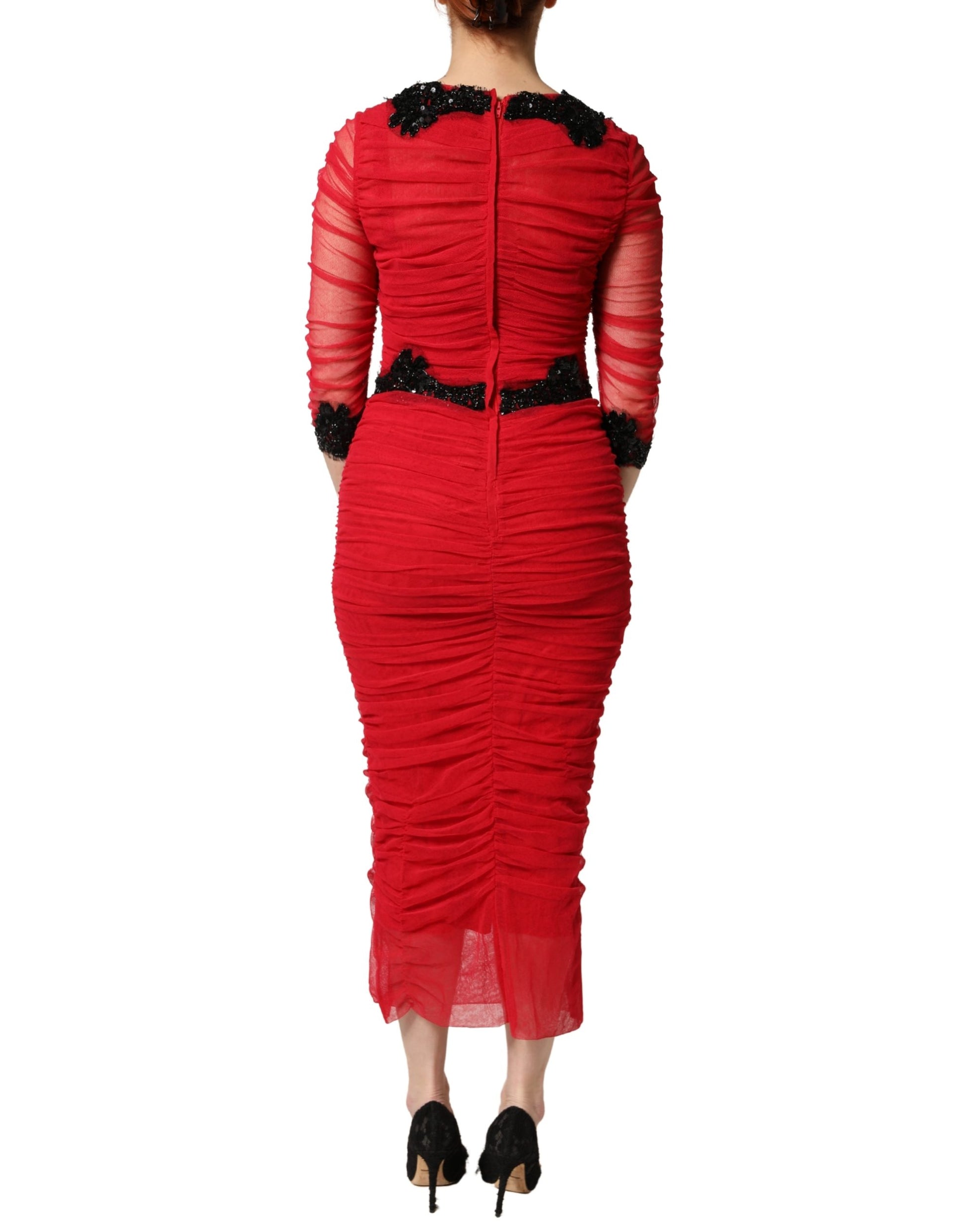 A red bodycon dress with mesh trim from Dolce & Gabbana, featuring a sheath silhouette and midi length