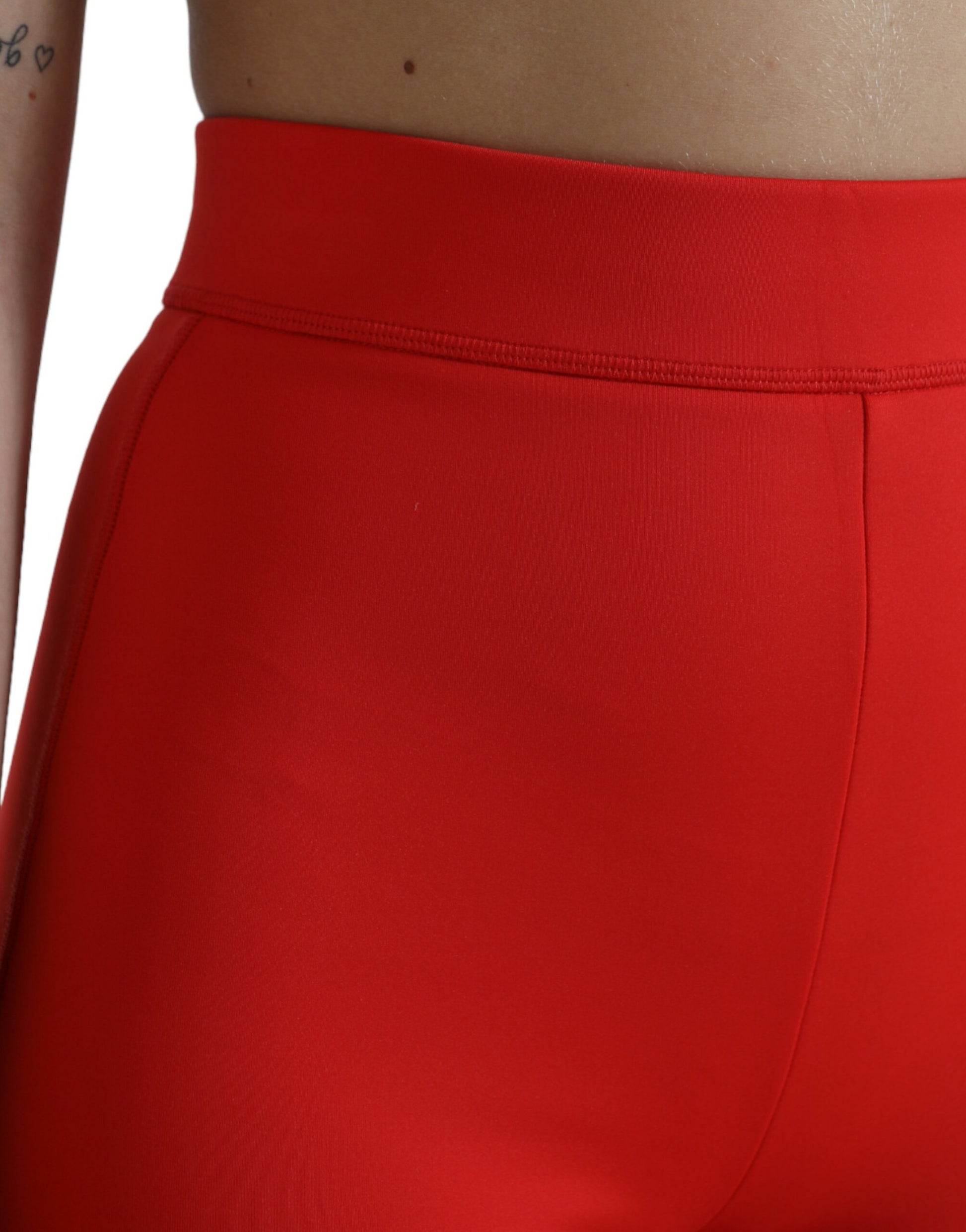 Red leggings on a person's waist