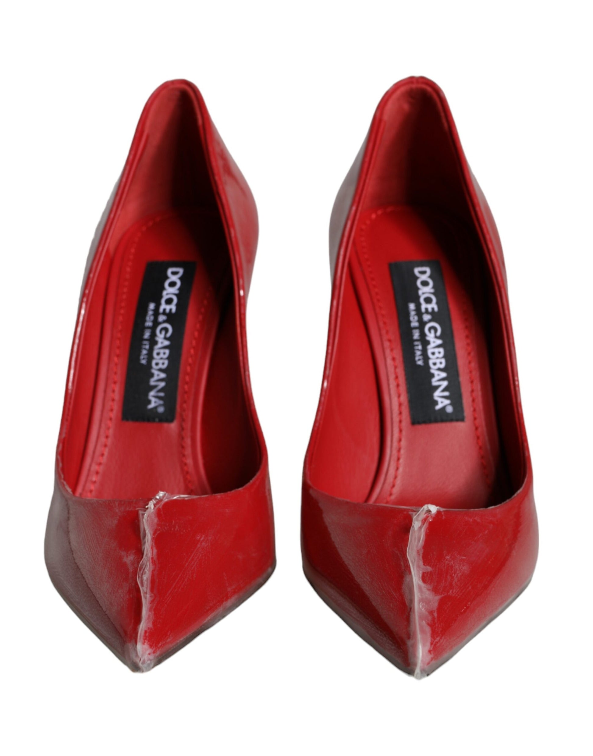 Red high heel shoes with a label on the insole