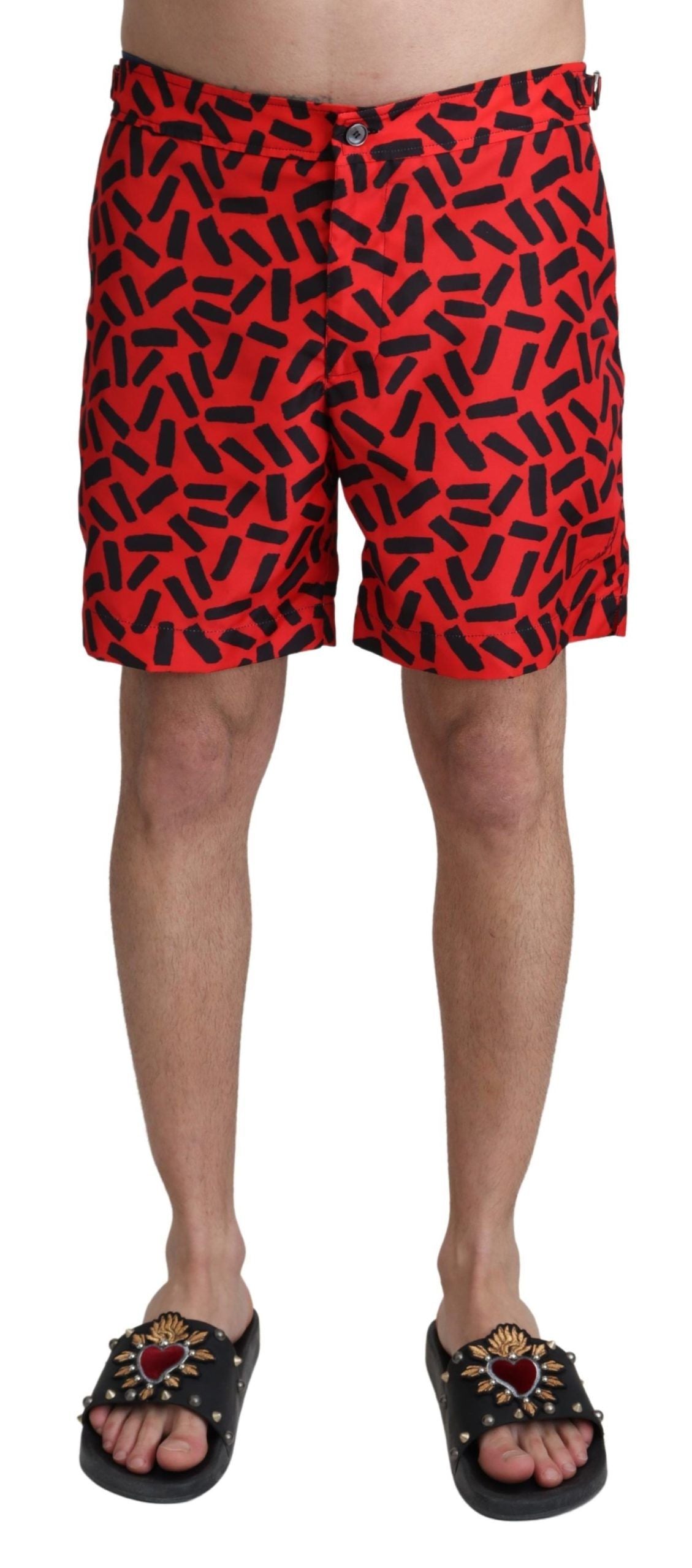 Red swim trunks with black pattern on man's legs