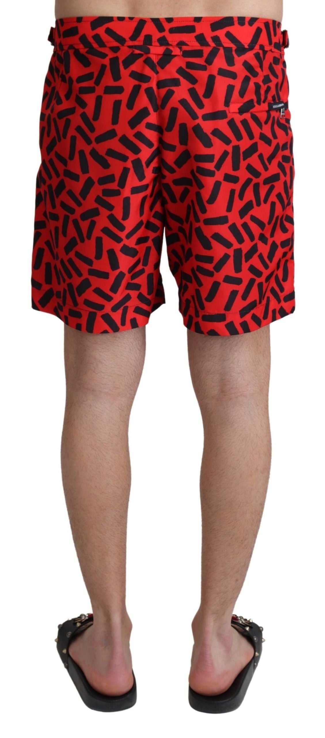 Red swim trunks with black pattern on mannequin