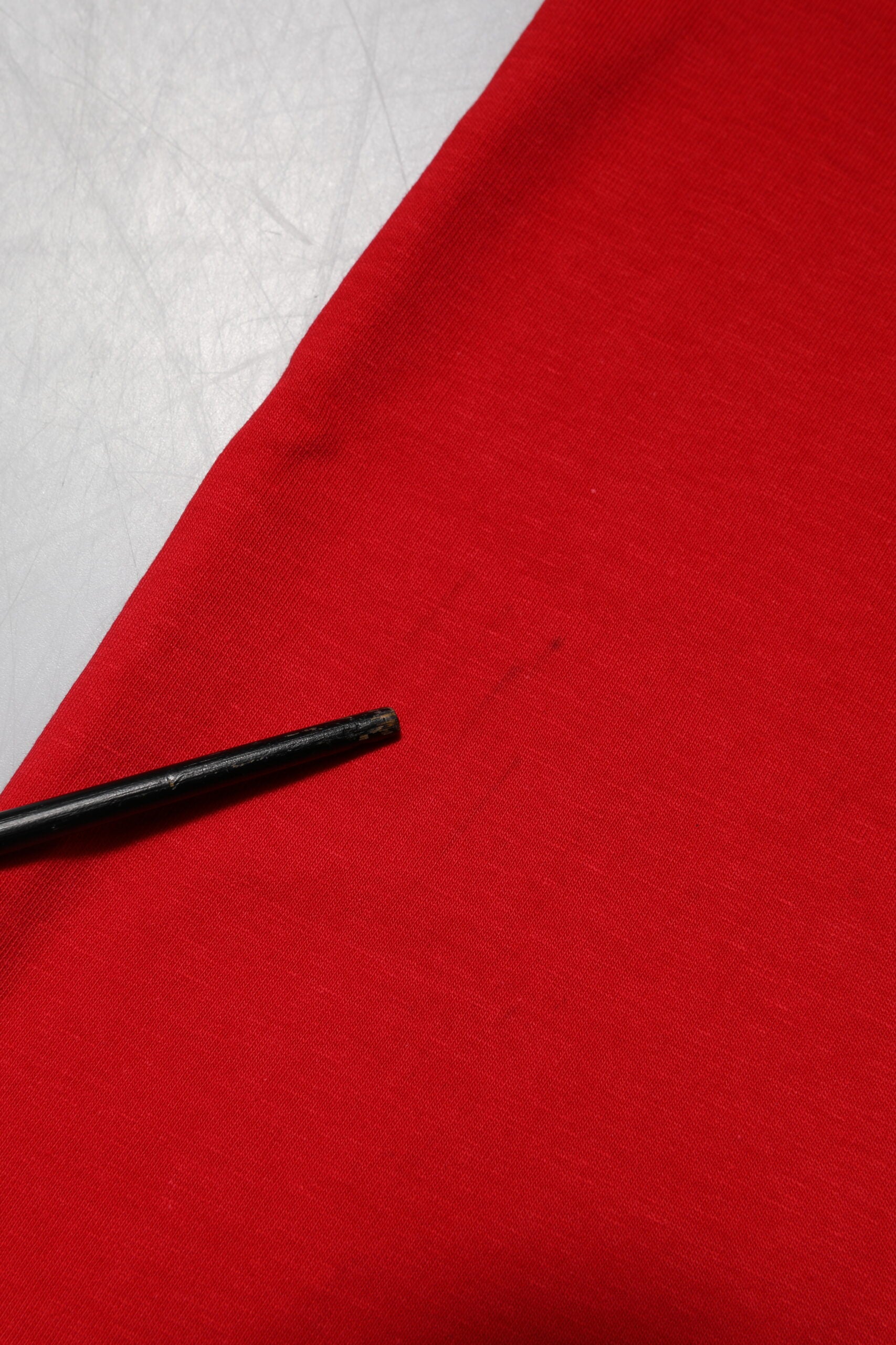 Black thread on red fabric