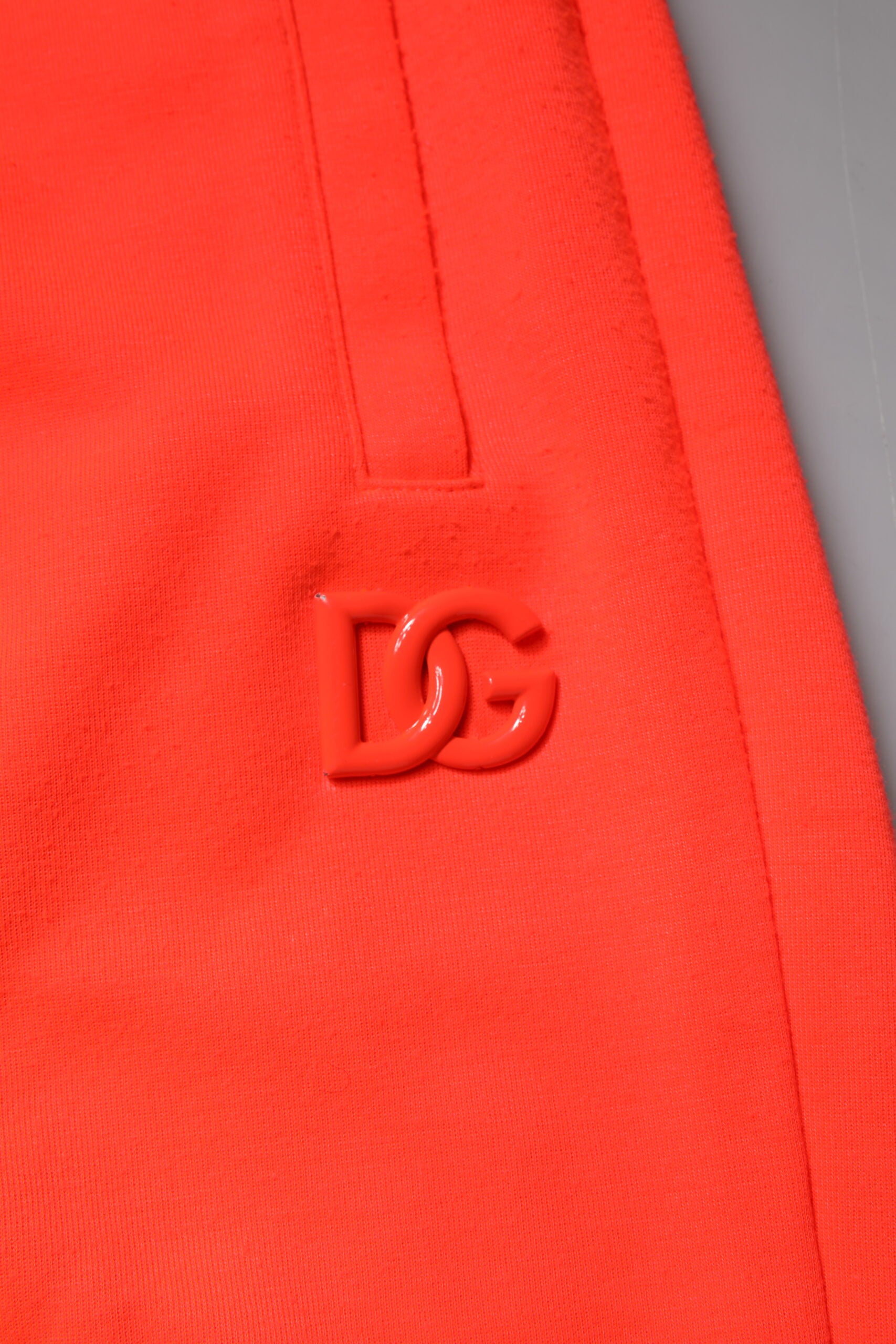 Red polyester mid waist men's bermuda shorts with a logo on the left leg