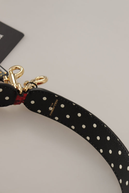 Black strap with white polka dots on a lanyard