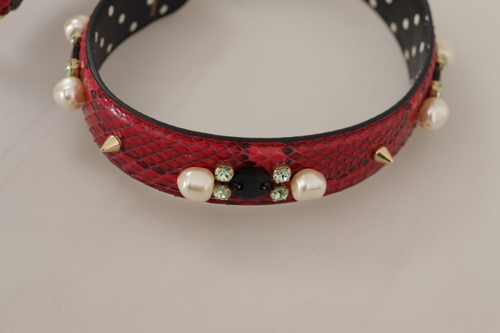 Red beaded collar with black leather trim and gold accents