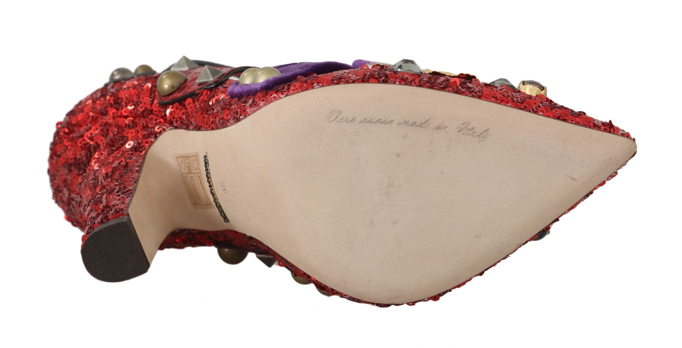 A pair of shoes with red glittery material on top and what appears to be a wooden sole. There is also a small piece of pa