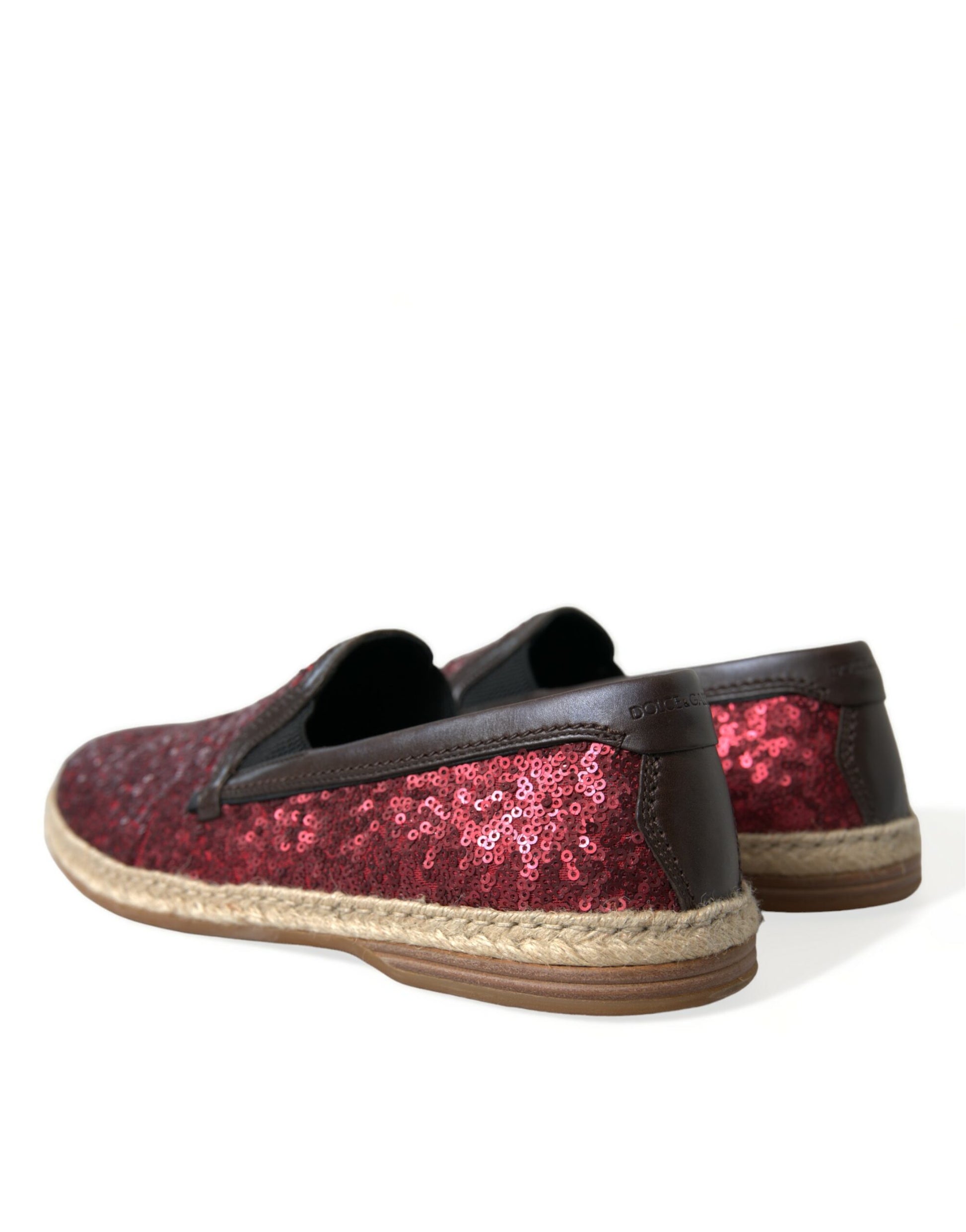 Pair of red glittery shoes with brown soles and black laces