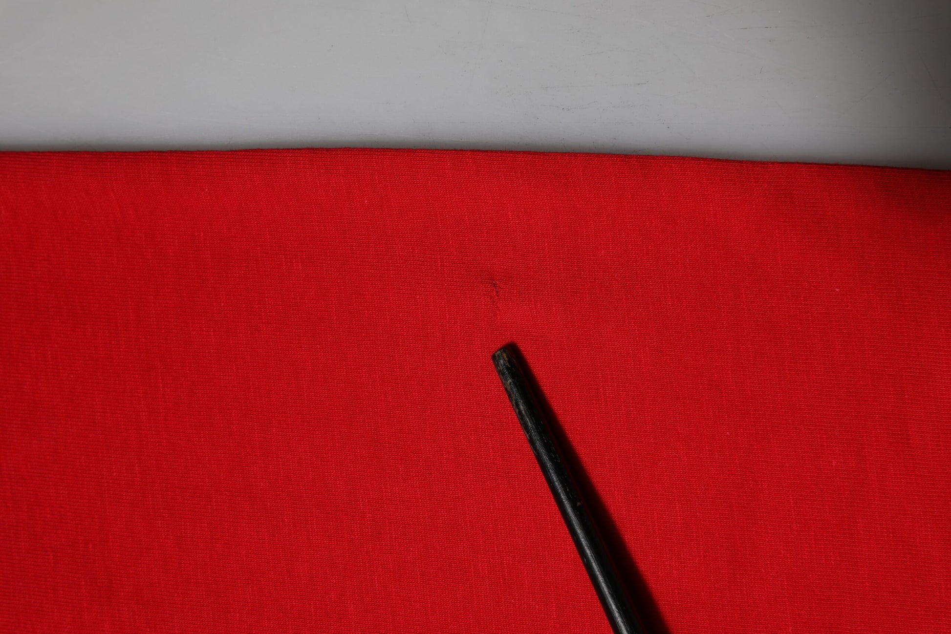 Black pen on red fabric