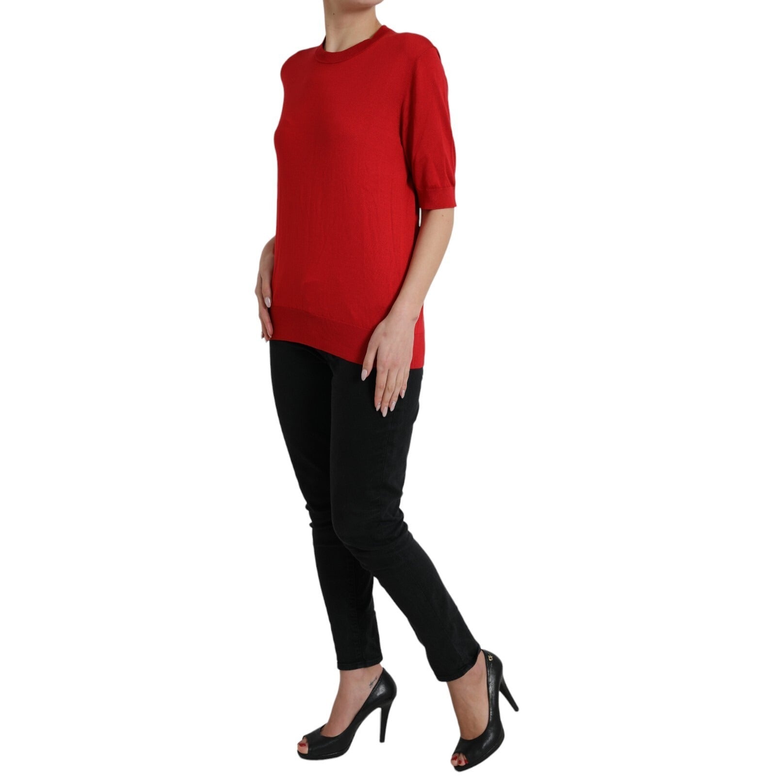 Woman wearing red sweater and black pants