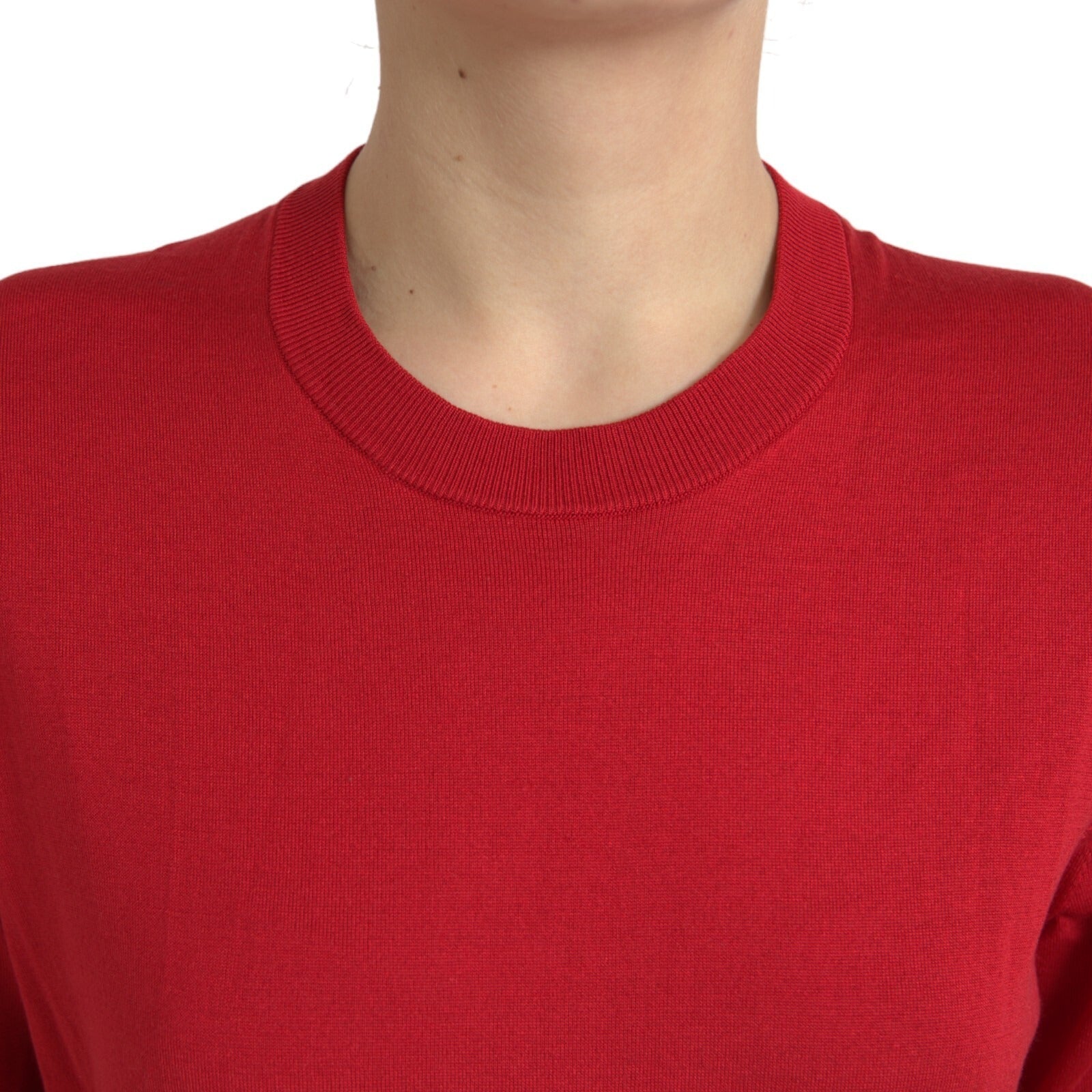 Red long sleeve sweater on a person's torso