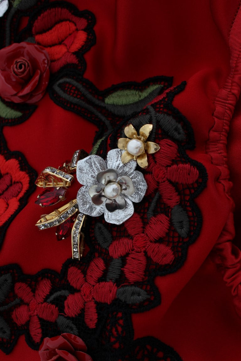 Decorative red fabric with embroidered flowers and gold accents