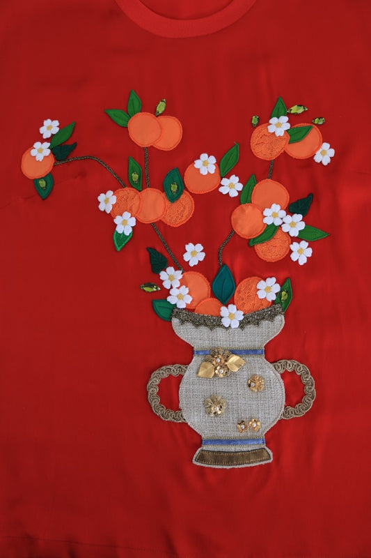Hand embroidered floral design on red fabric