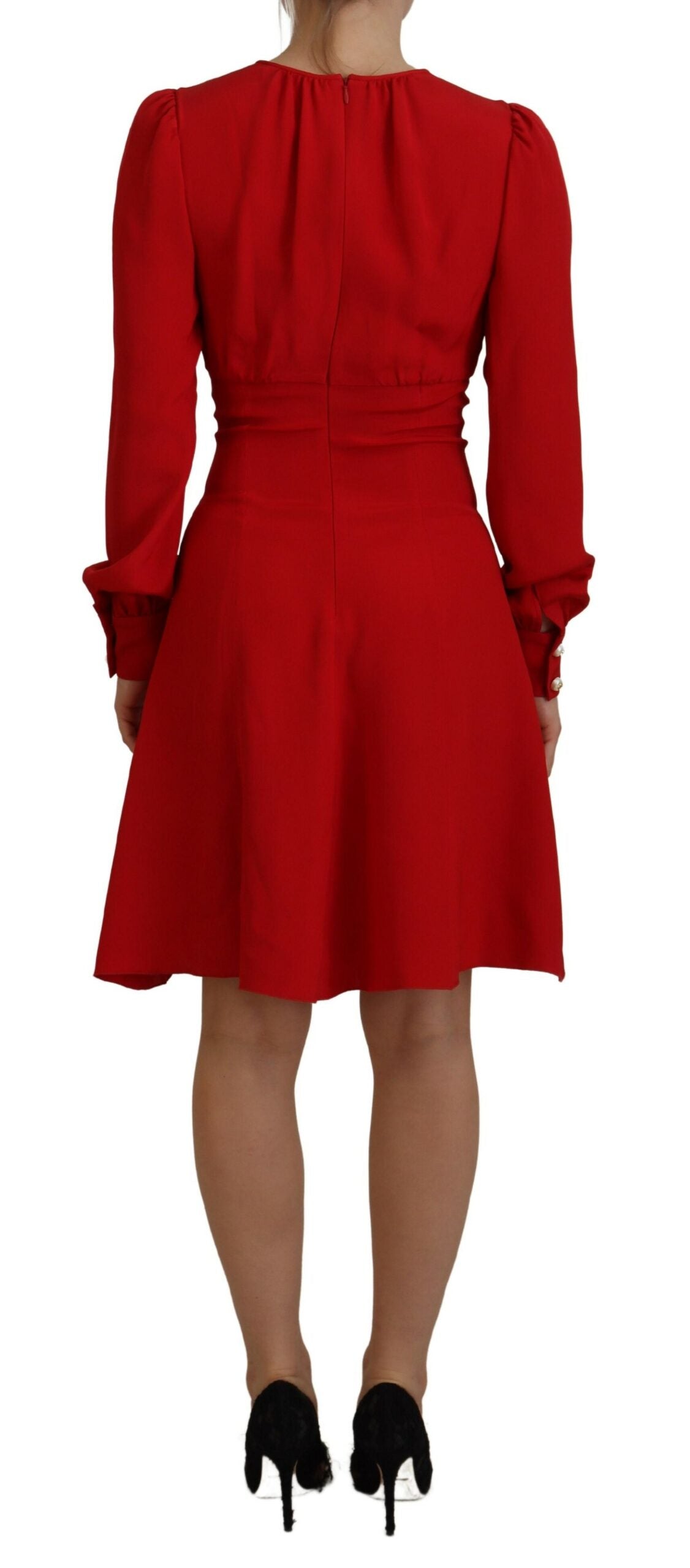 A red silk sheath dress with an A-line cut and knee length. It features a fitted bodice with ruffled sleeves