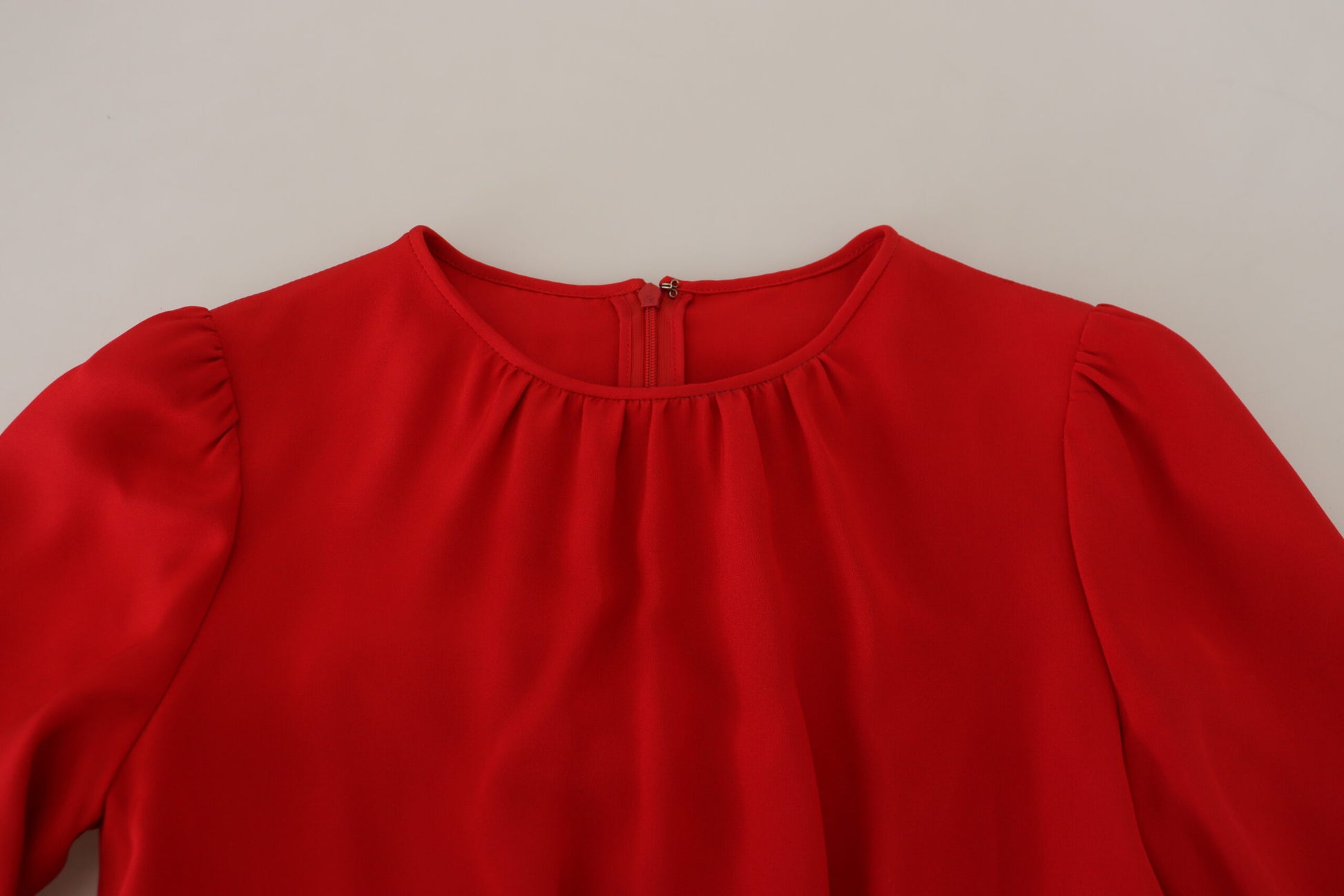 Red silk sheath dress with ruffled neckline and sleeves