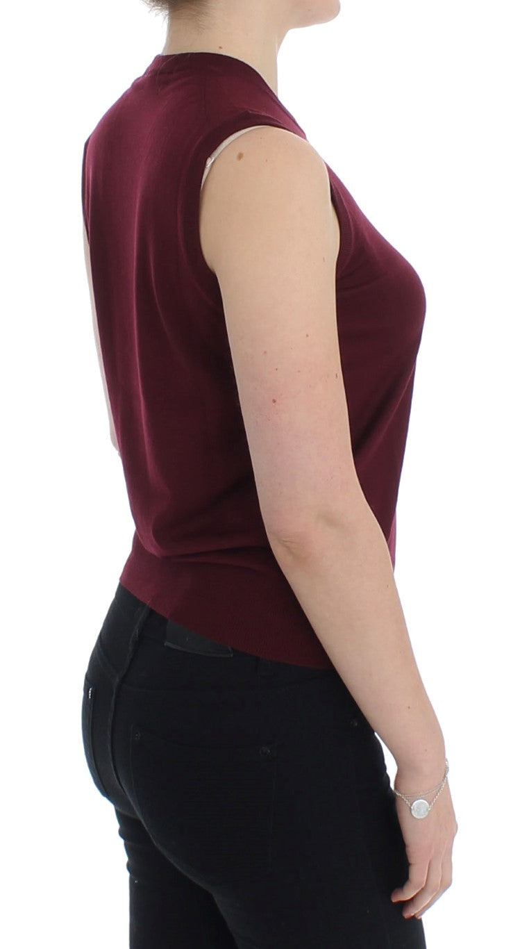 Woman wearing burgundy top and black pants