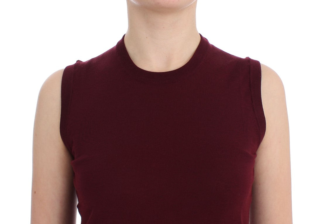 Woman wearing a maroon knit top with short sleeves and off-the-shoulder design