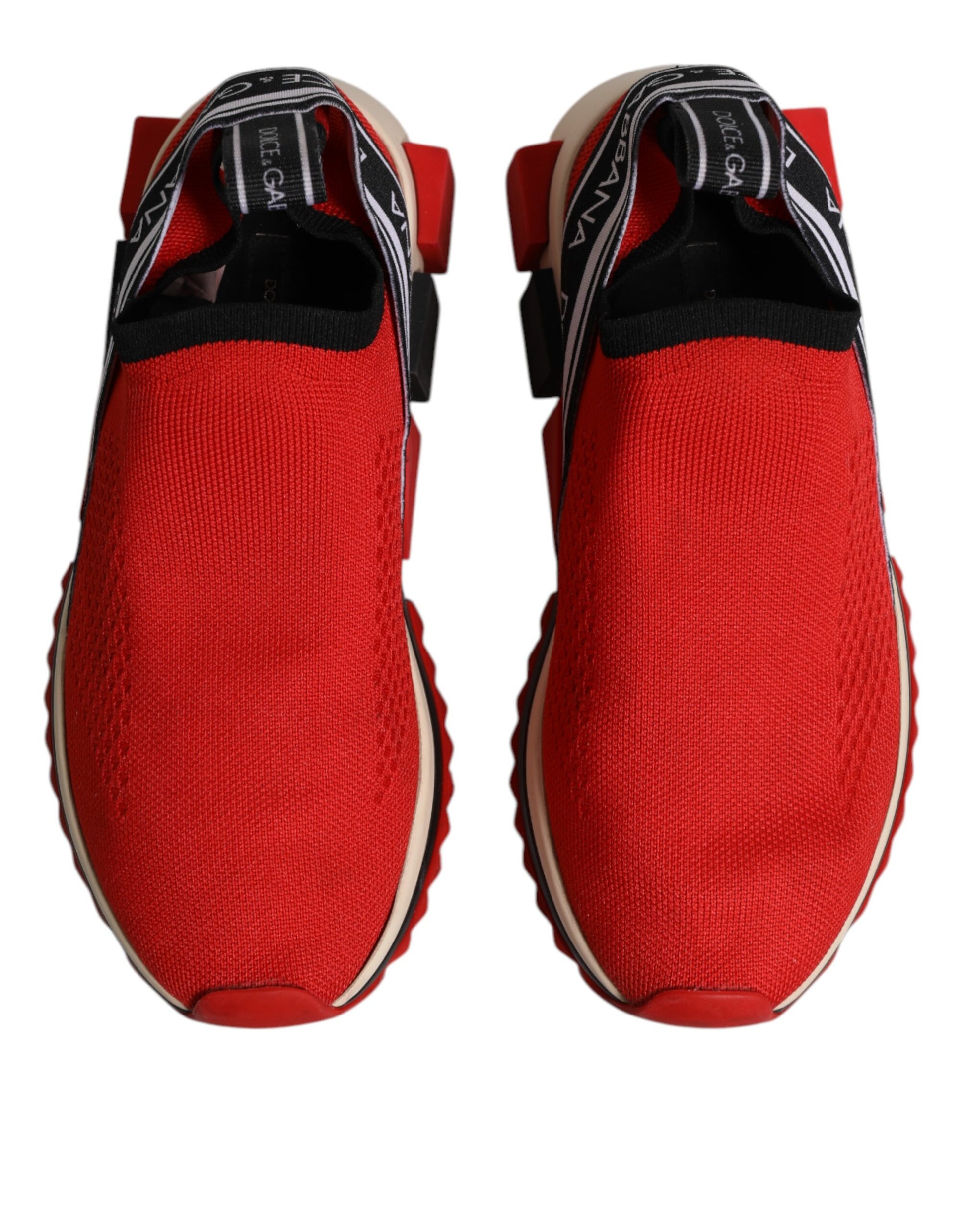 Pair of red slip-on shoes with white soles and black laces