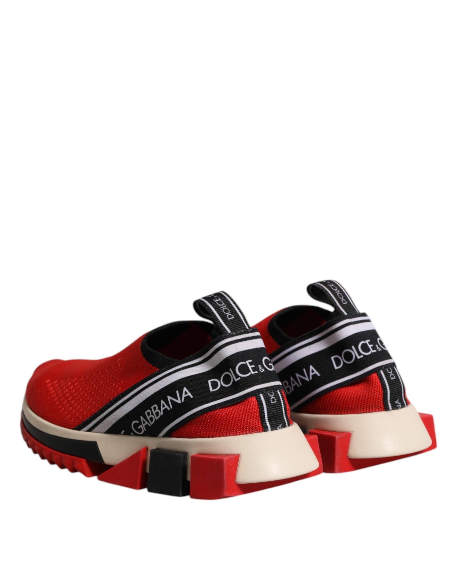 Red slip-on shoes with white soles and black straps, featuring the Dolce & Gabbana logo