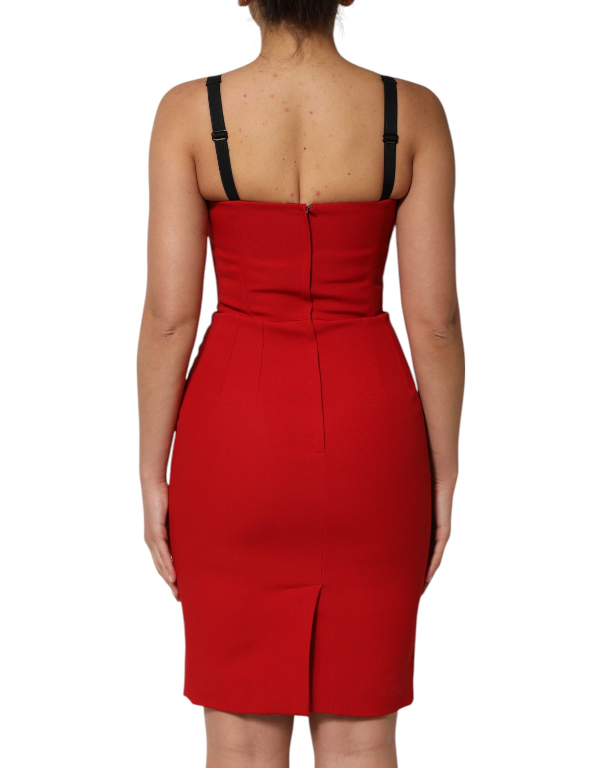 A red knee-length dress with a fitted silhouette and black straps