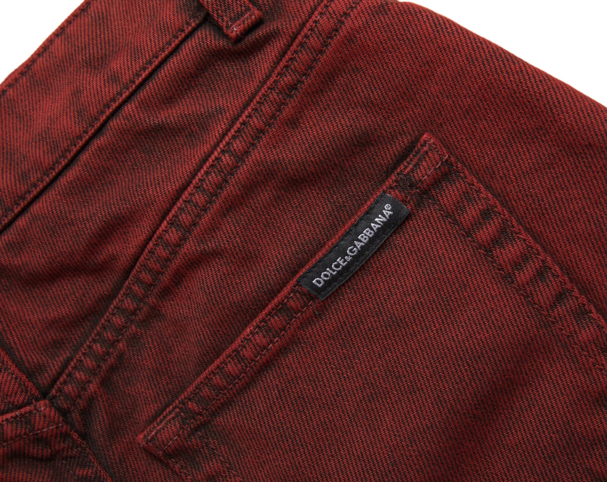 Red denim jeans with a label on the waistband