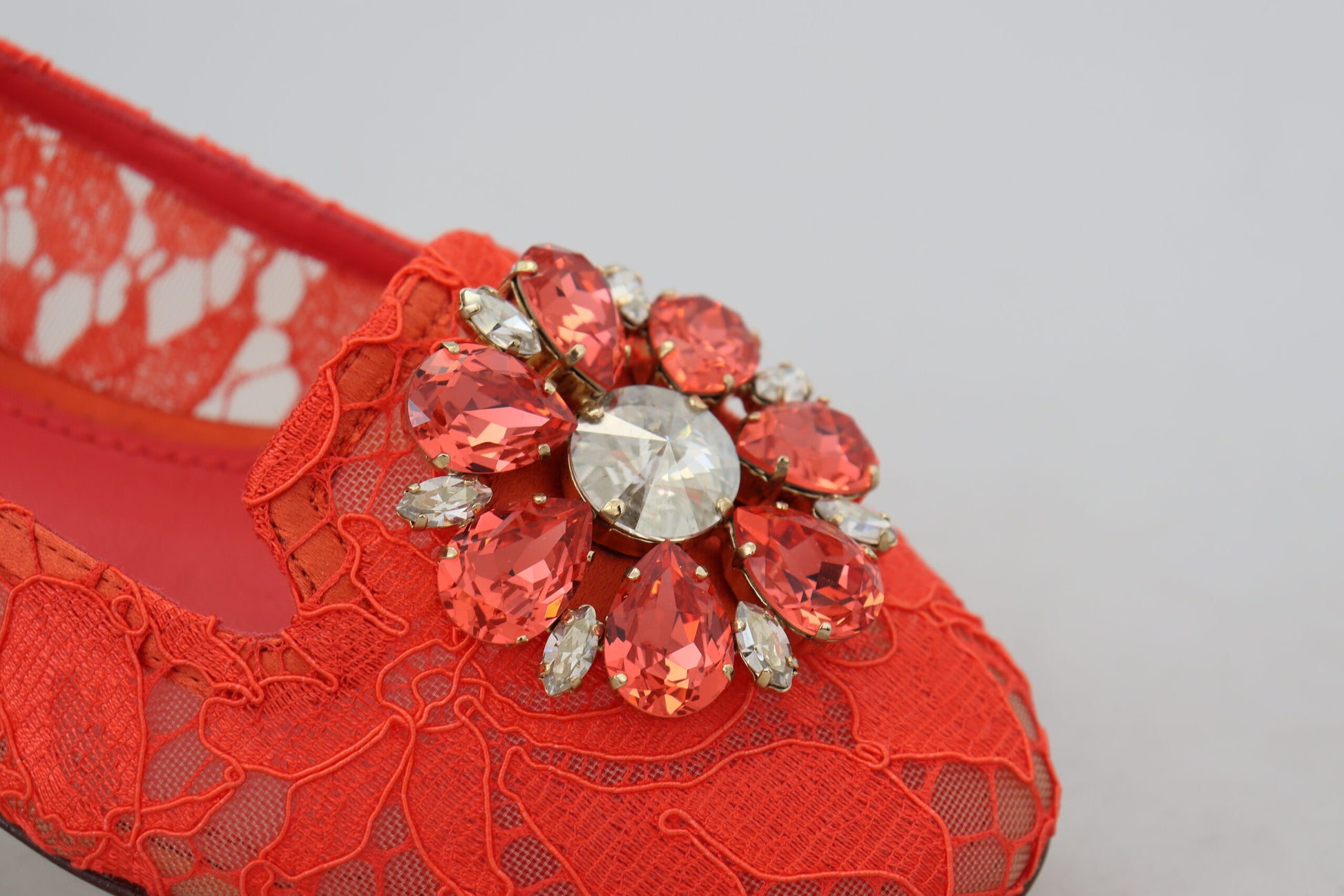 Red lace shoe with a large red and clear crystal brooch on top