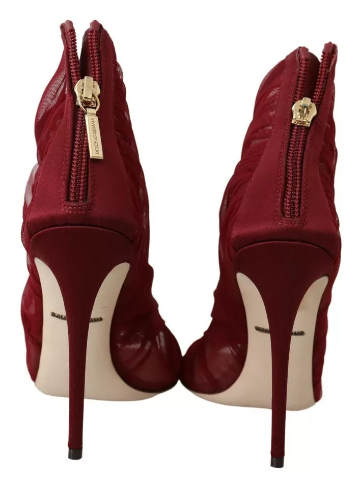 Pair of red high heel shoes with gold accents