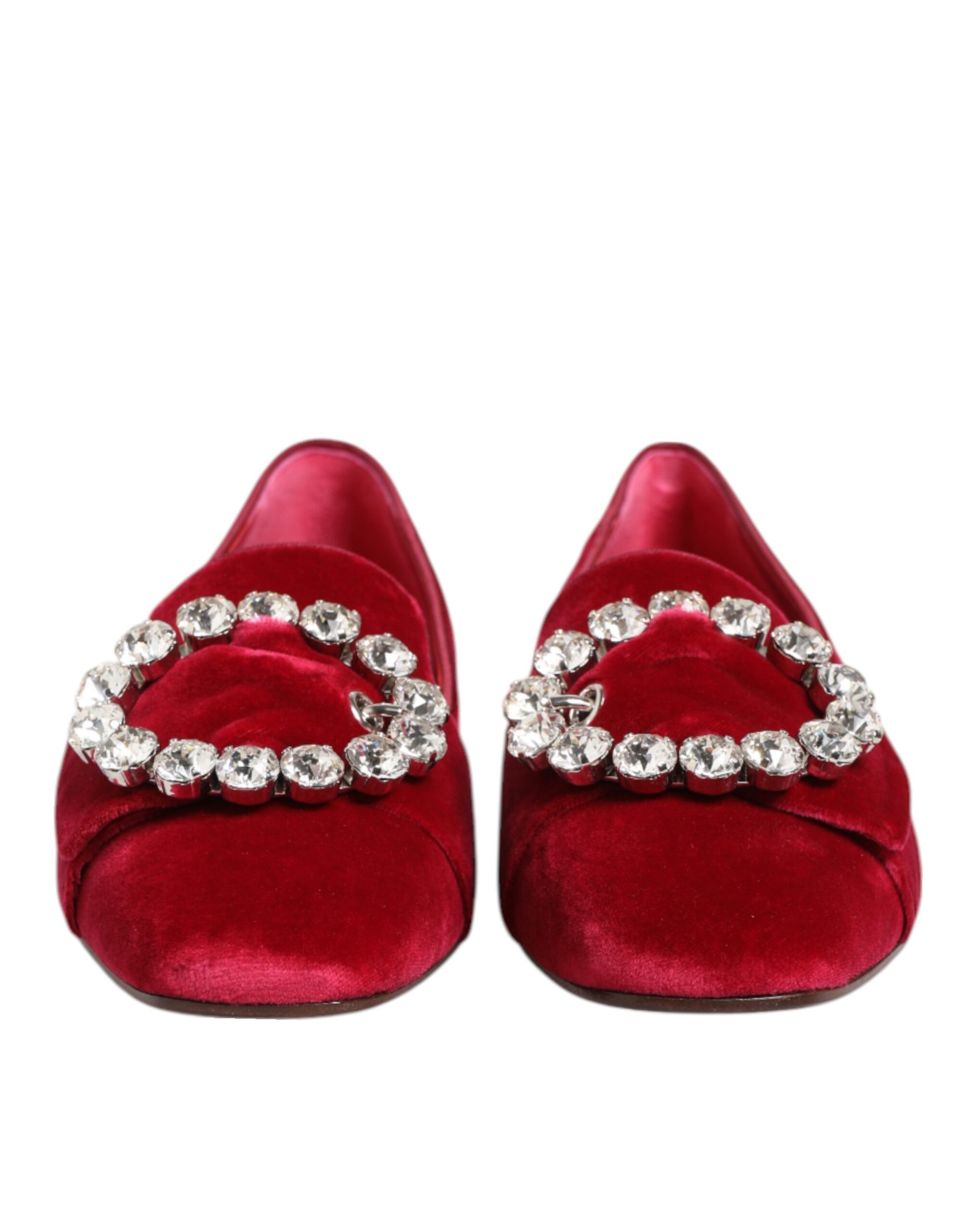 Pair of red velvet shoes with sparkling jewelry on top