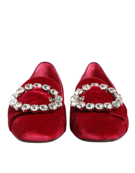 Pair of red velvet shoes with sparkling jewelry on top