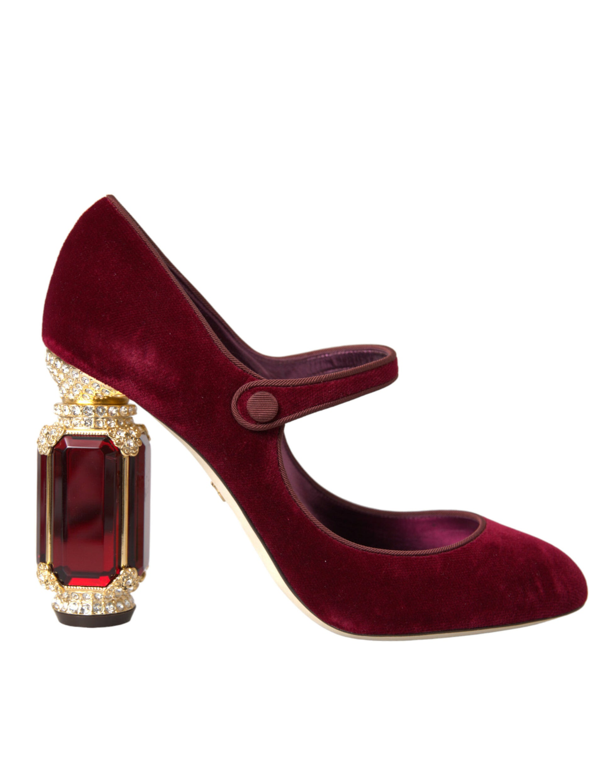 Red velvet high heel shoe with gold accents and a red crystal on the toe