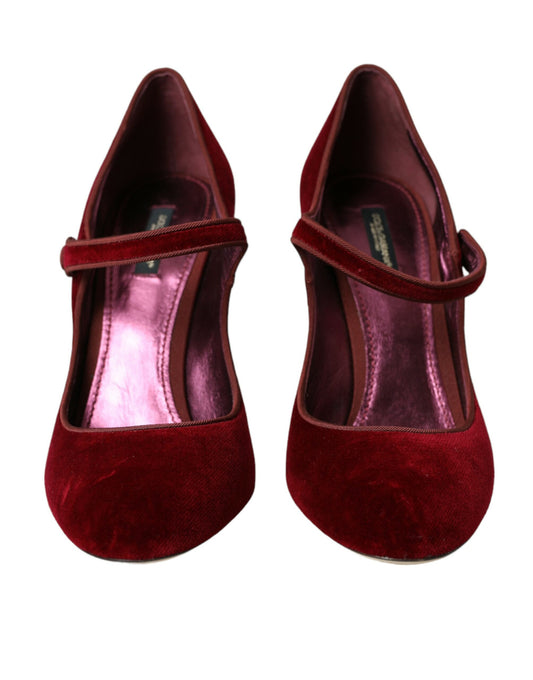 Pair of red velvet shoes with a strap and heel