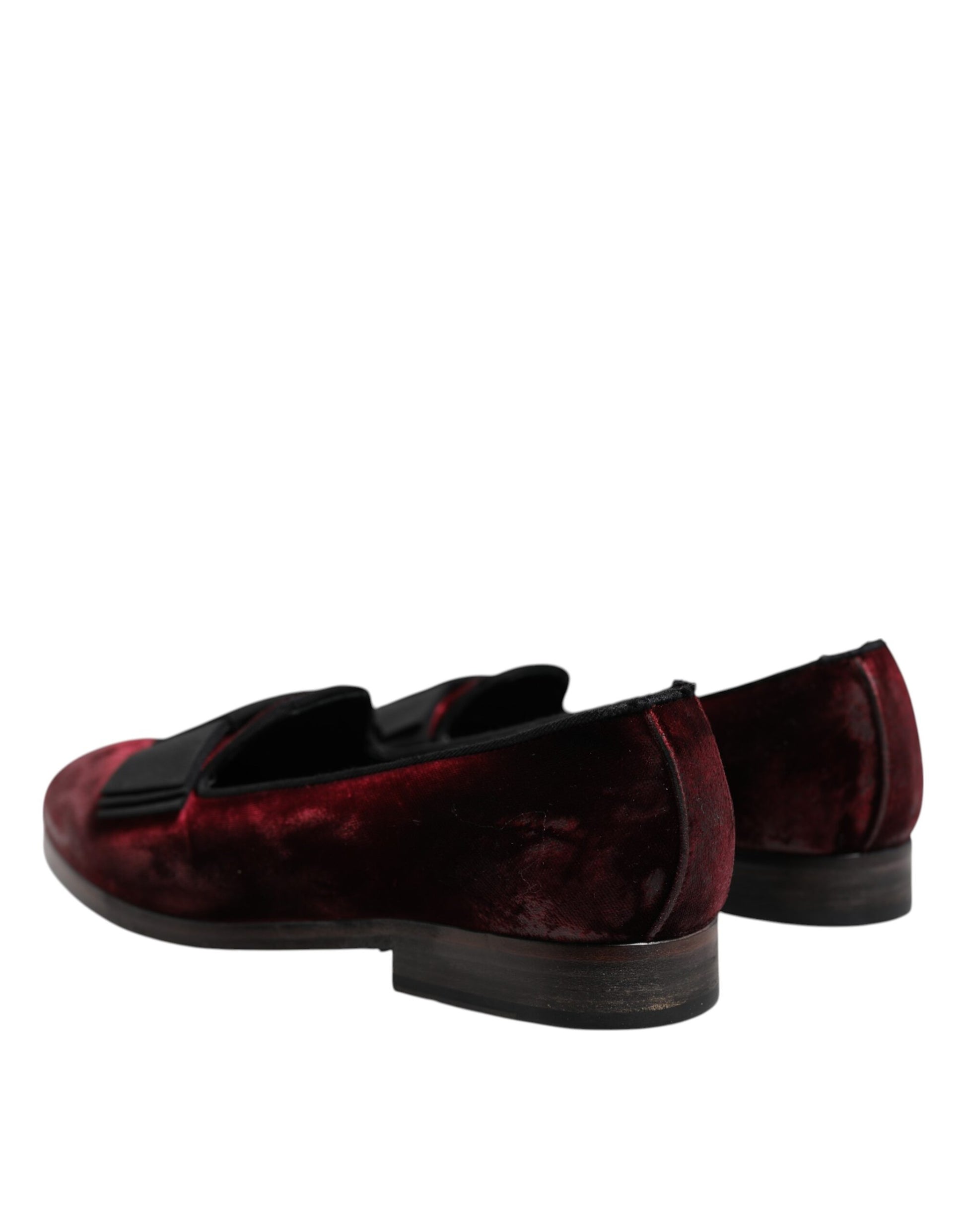 A pair of red velvet men's slip-on loafers with a black sole