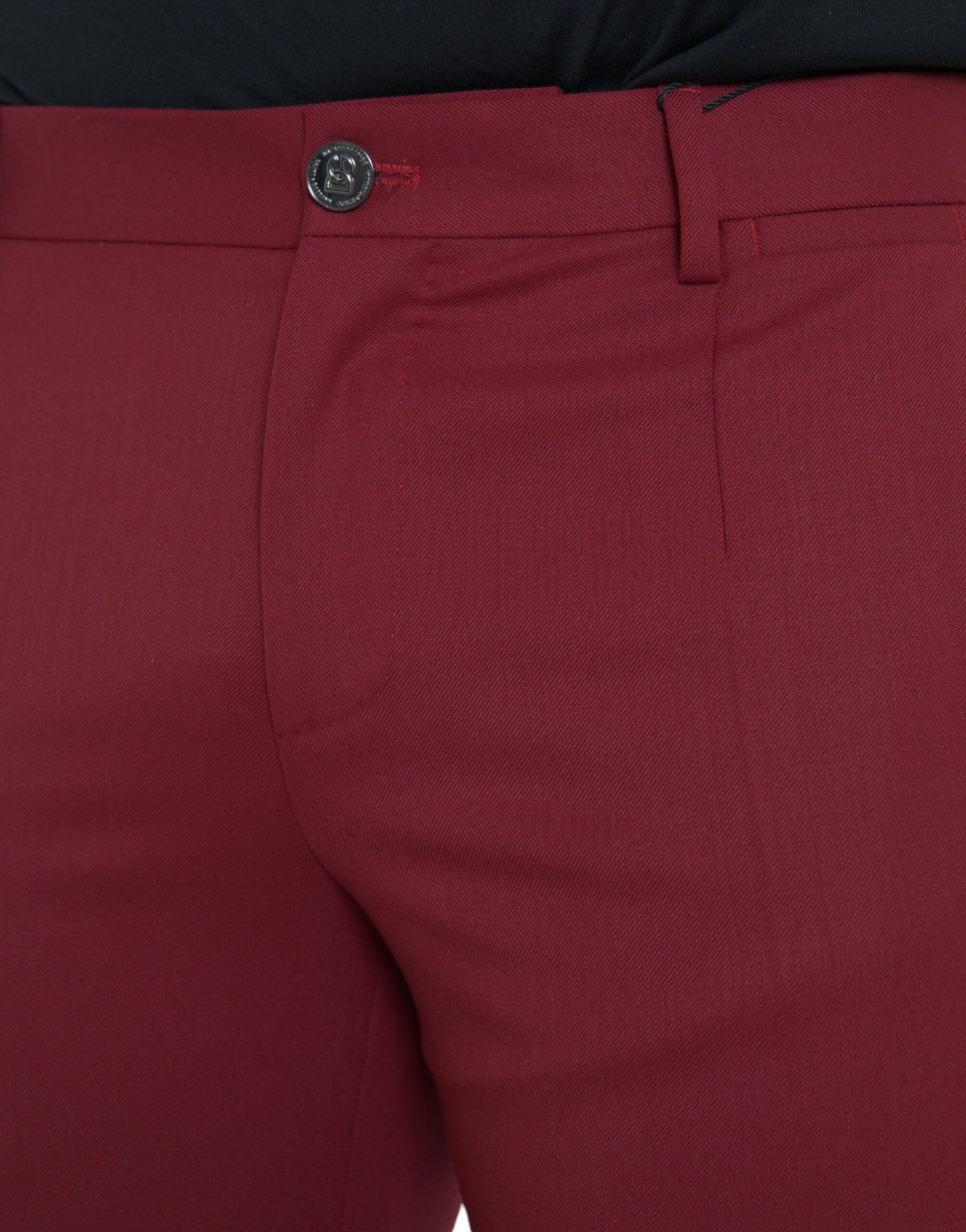 A pair of red wool men's slim fit dress pants with a black button and belt loops