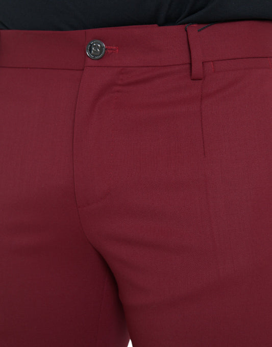 A pair of red wool men's slim fit dress pants with a black button and belt loops