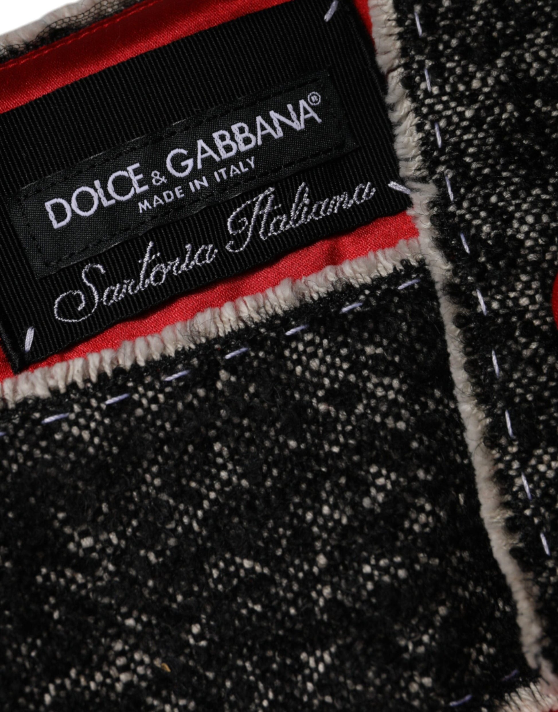 A close-up of a red wool dress with a flared A-line design. It features the Dolce & Gabbana logo on the left
