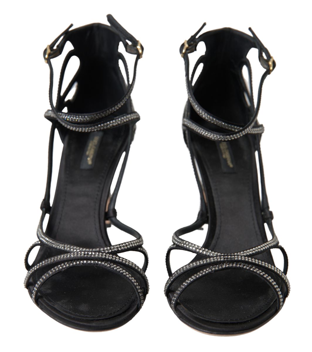Pair of black high heel shoes with embellishments and straps