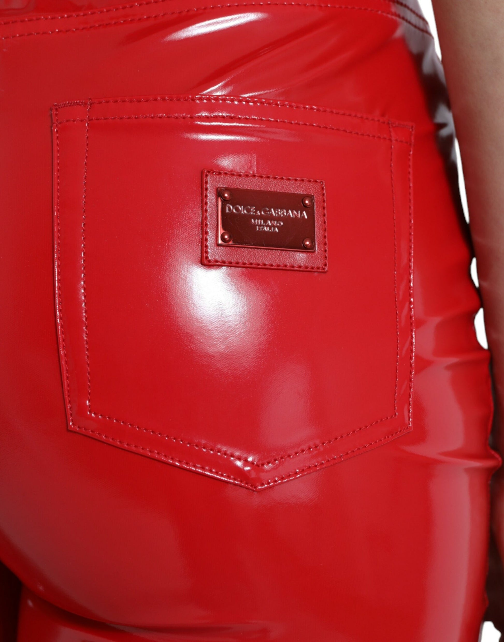 Red leather pants with a brand label on the back pocket