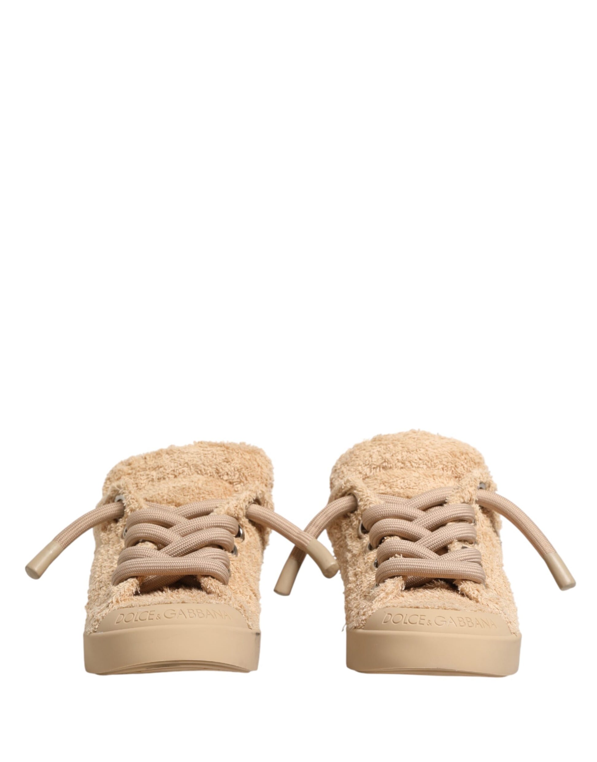 Pair of beige faux shearling low top sneakers with laces and a small bow on the side